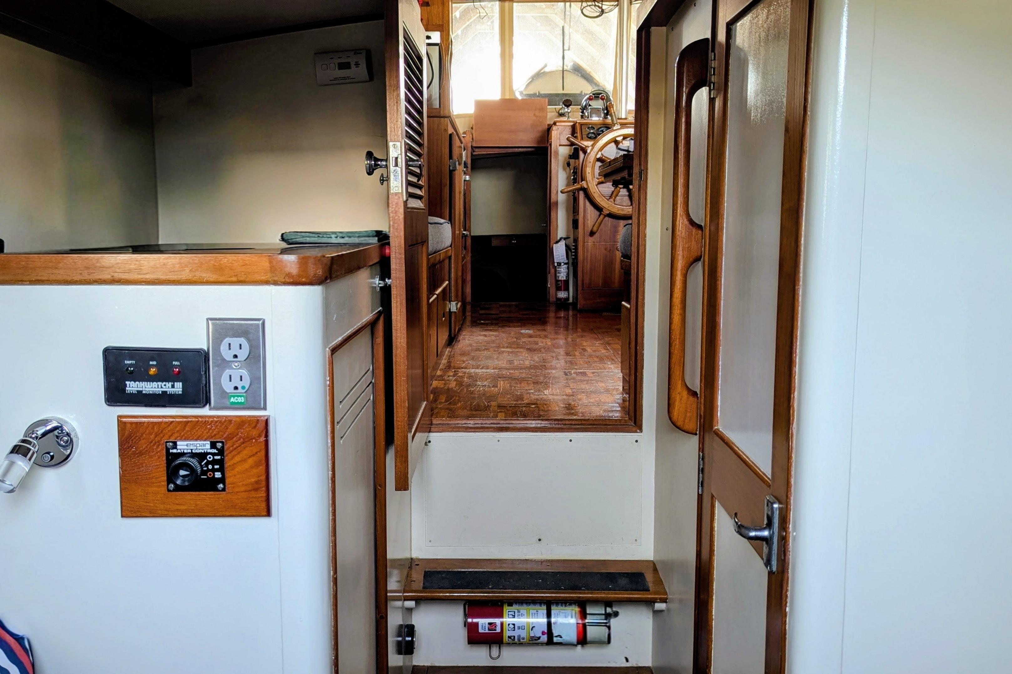 Interior view of 1974 Grand Banks 36 Classic boat, showcasing wooden helm and controls.