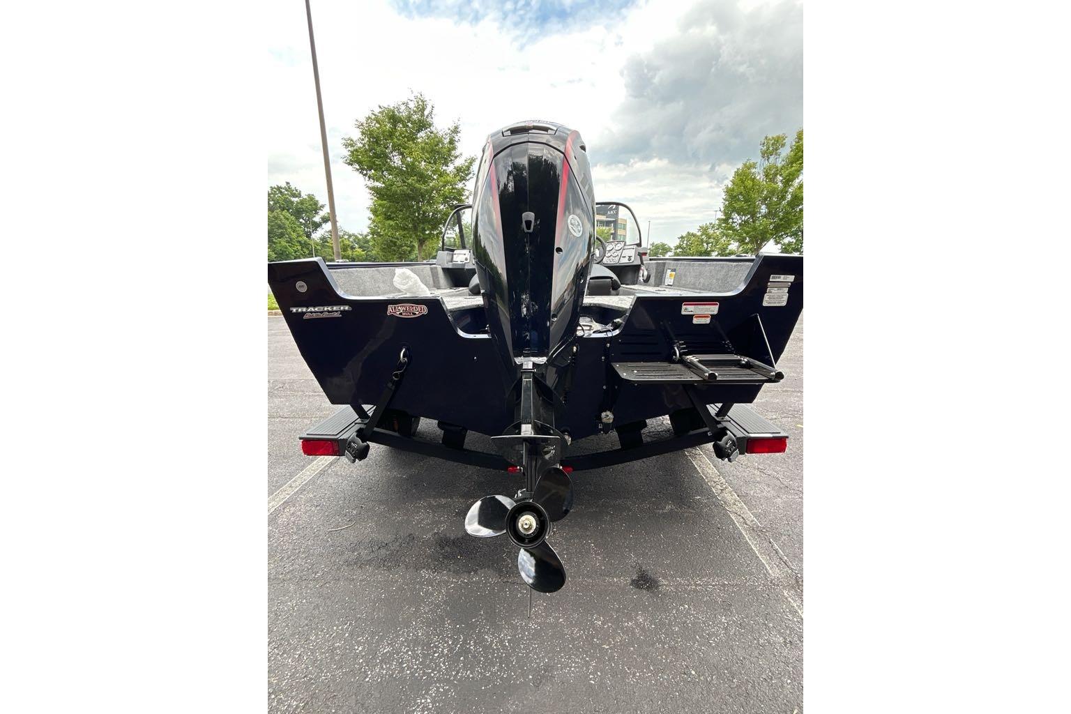 2025 Tracker Pro Guide V-175 WT boat rear view, parked outdoors on pavement.