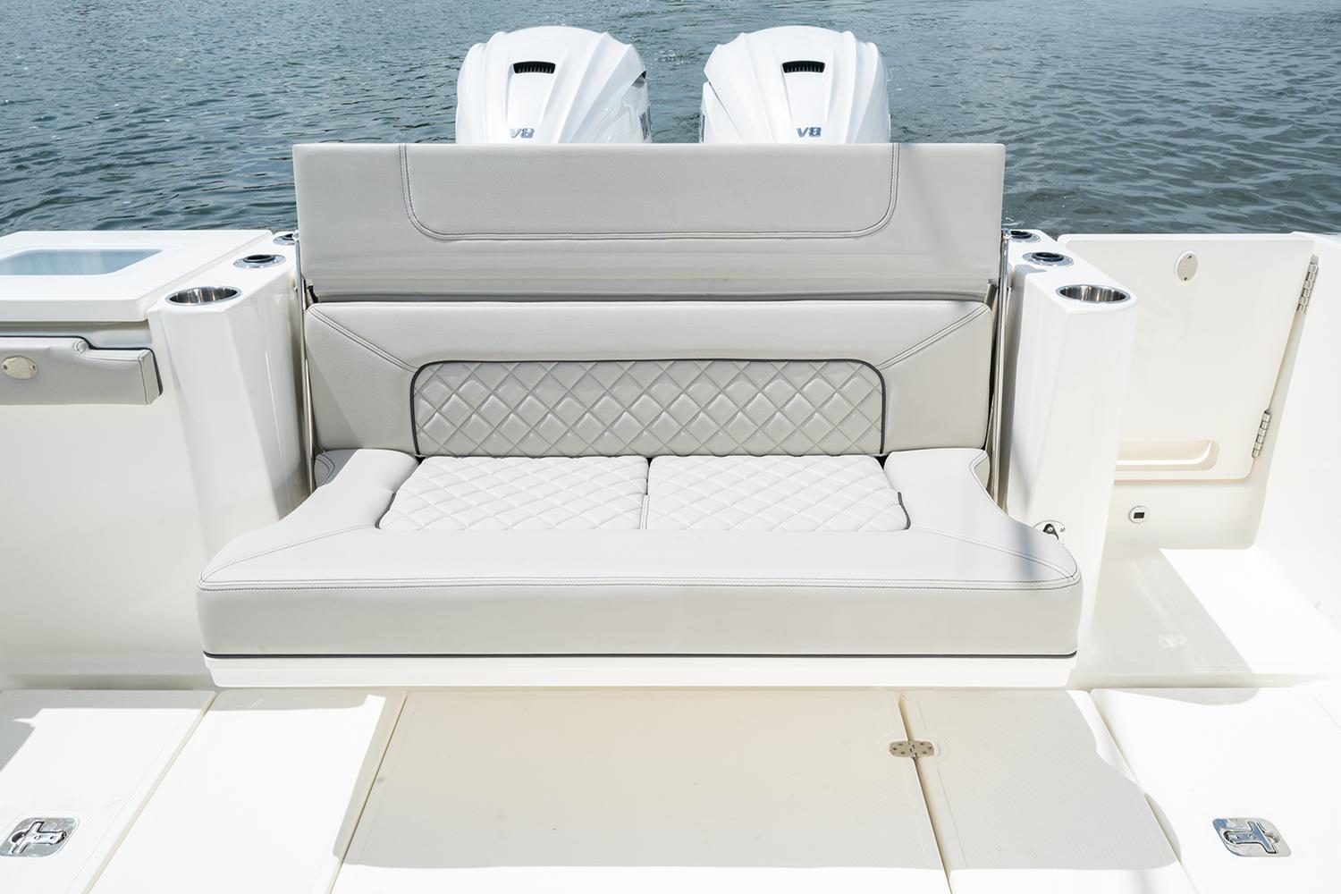 Manufacturer Provided Image: 2025 Pursuit S 358 Sport boat with luxurious seating and twin engines on a calm water backdrop.