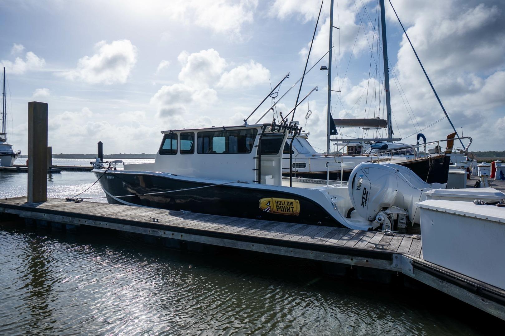 Custom Nerowalker 35 boat docked at marina, 2024 model, under cloudy sky.