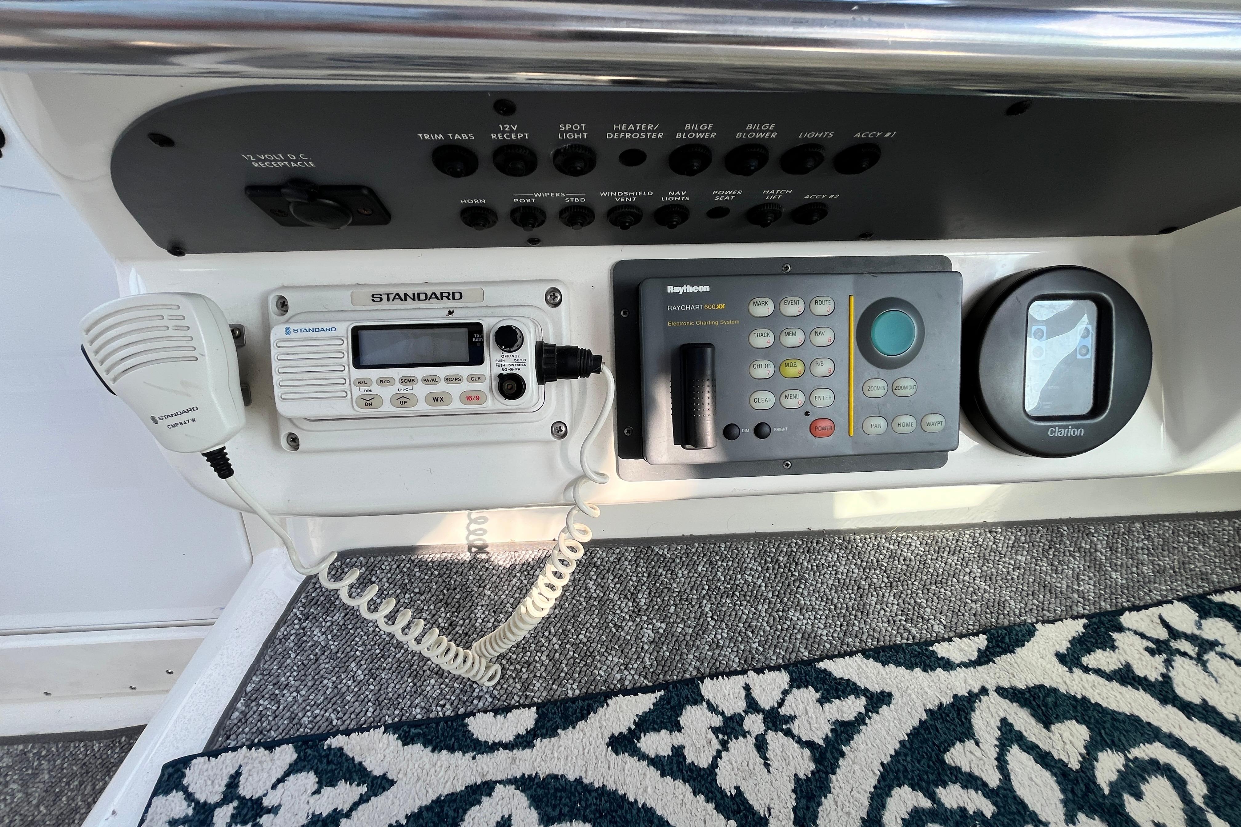 Control panel of a 1995 Sea Ray Sundancer 330 with radio and navigation systems.