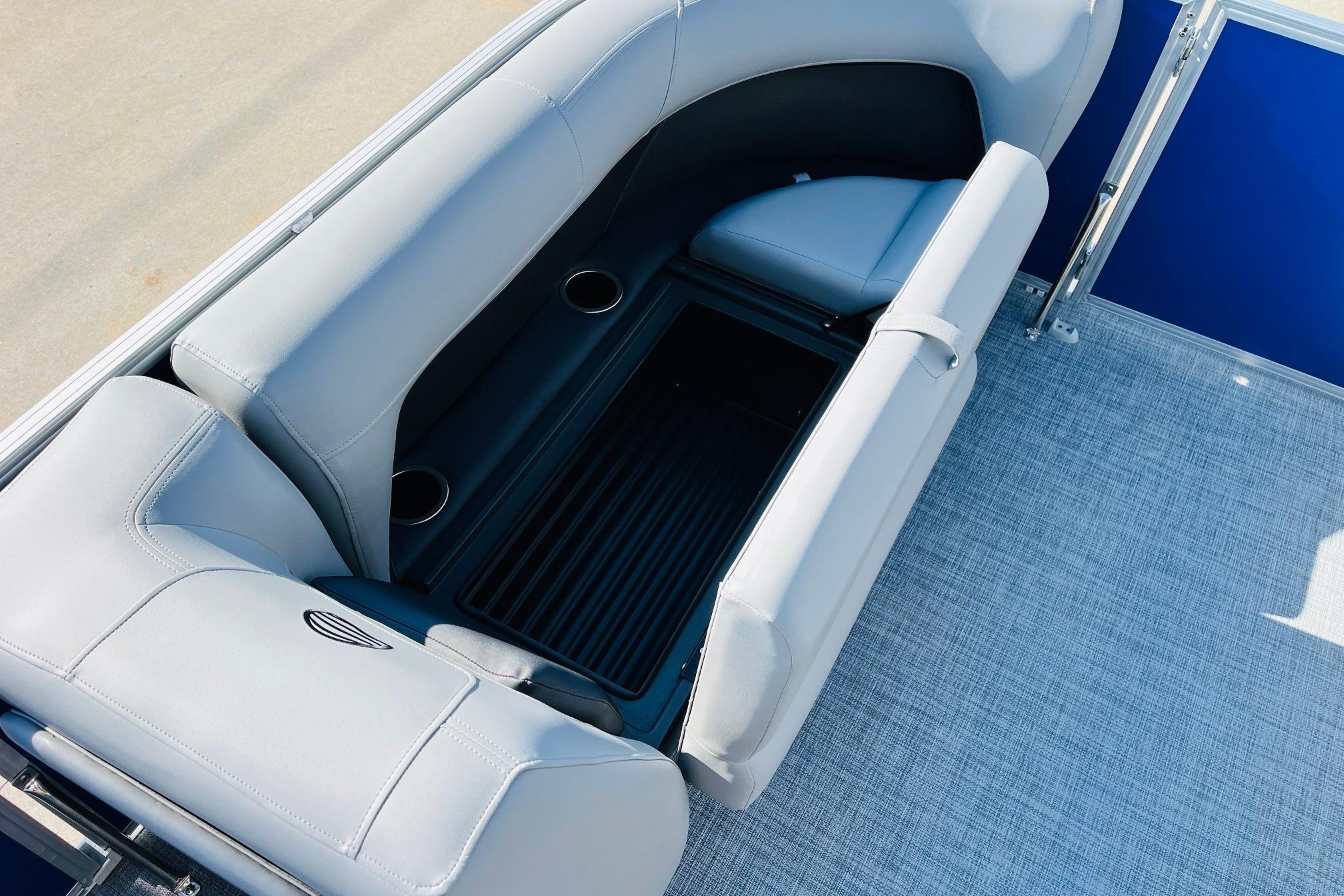 2026 Sun Tracker Party Barge 18 DLX interior seating with cup holders and storage.