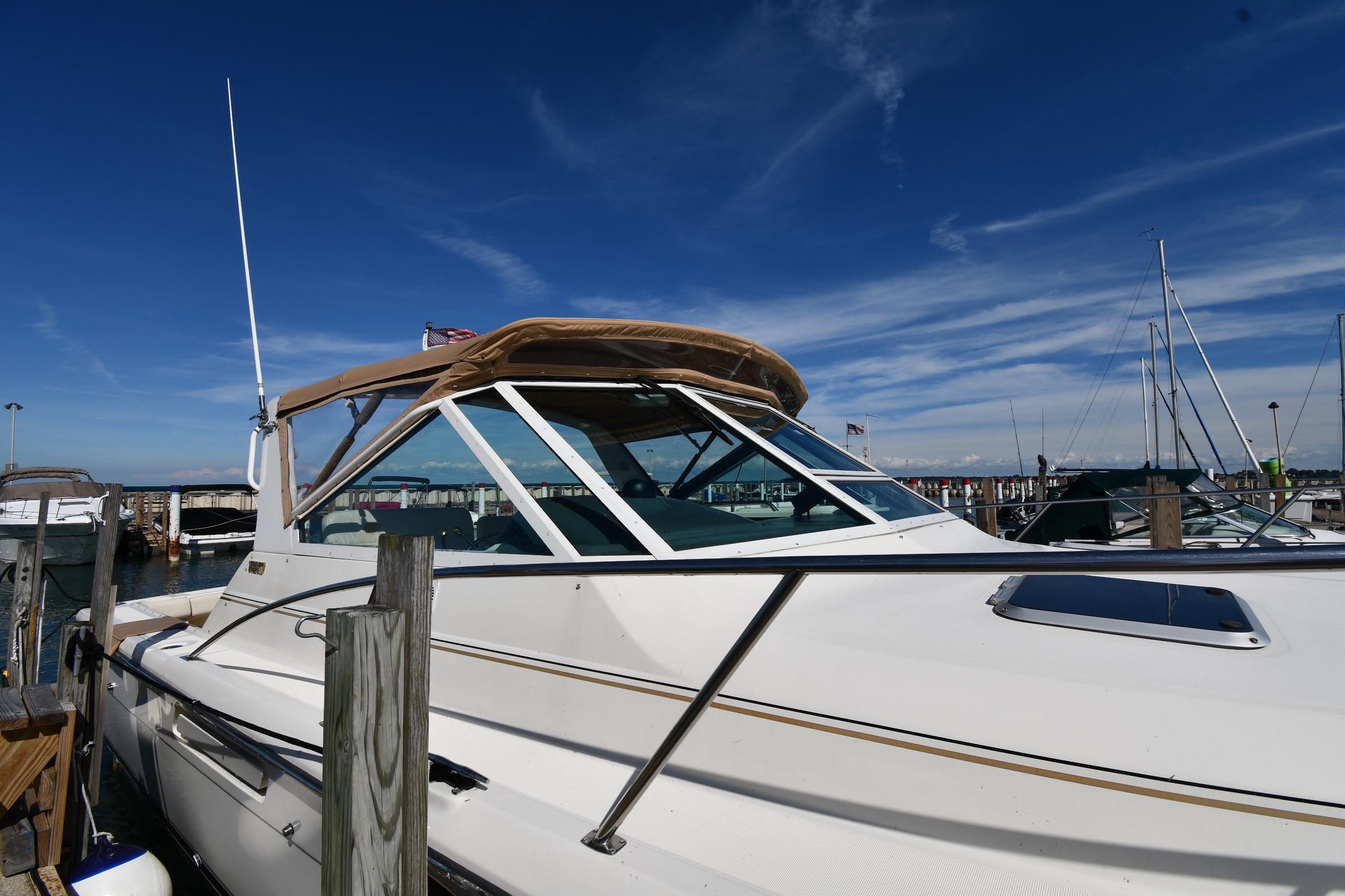 1998 Tiara Yachts 3100 Open docked under clear blue sky.