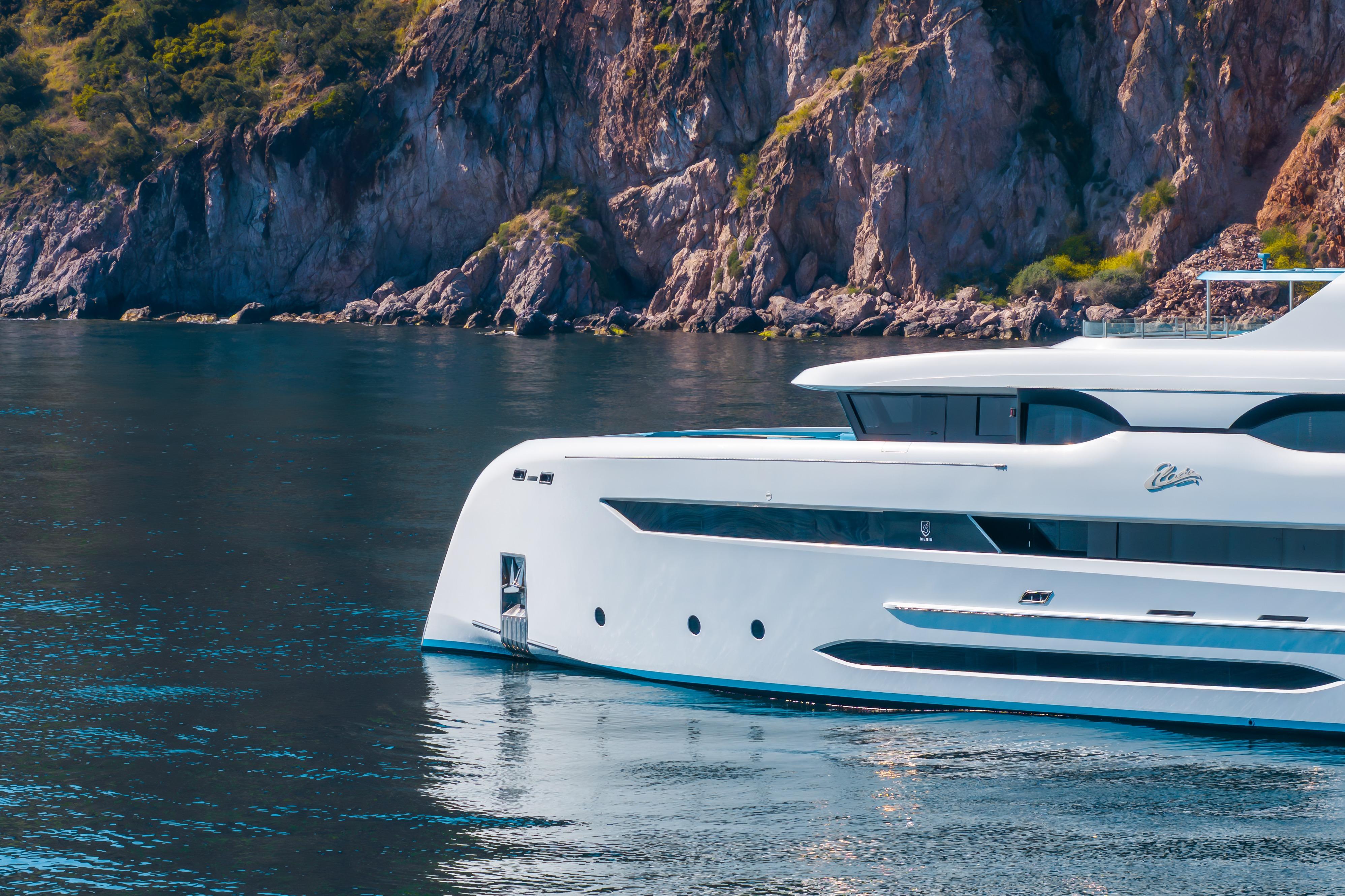 Luxurious Bilgin 147 yacht cruising near rocky coastline, 2014 model.