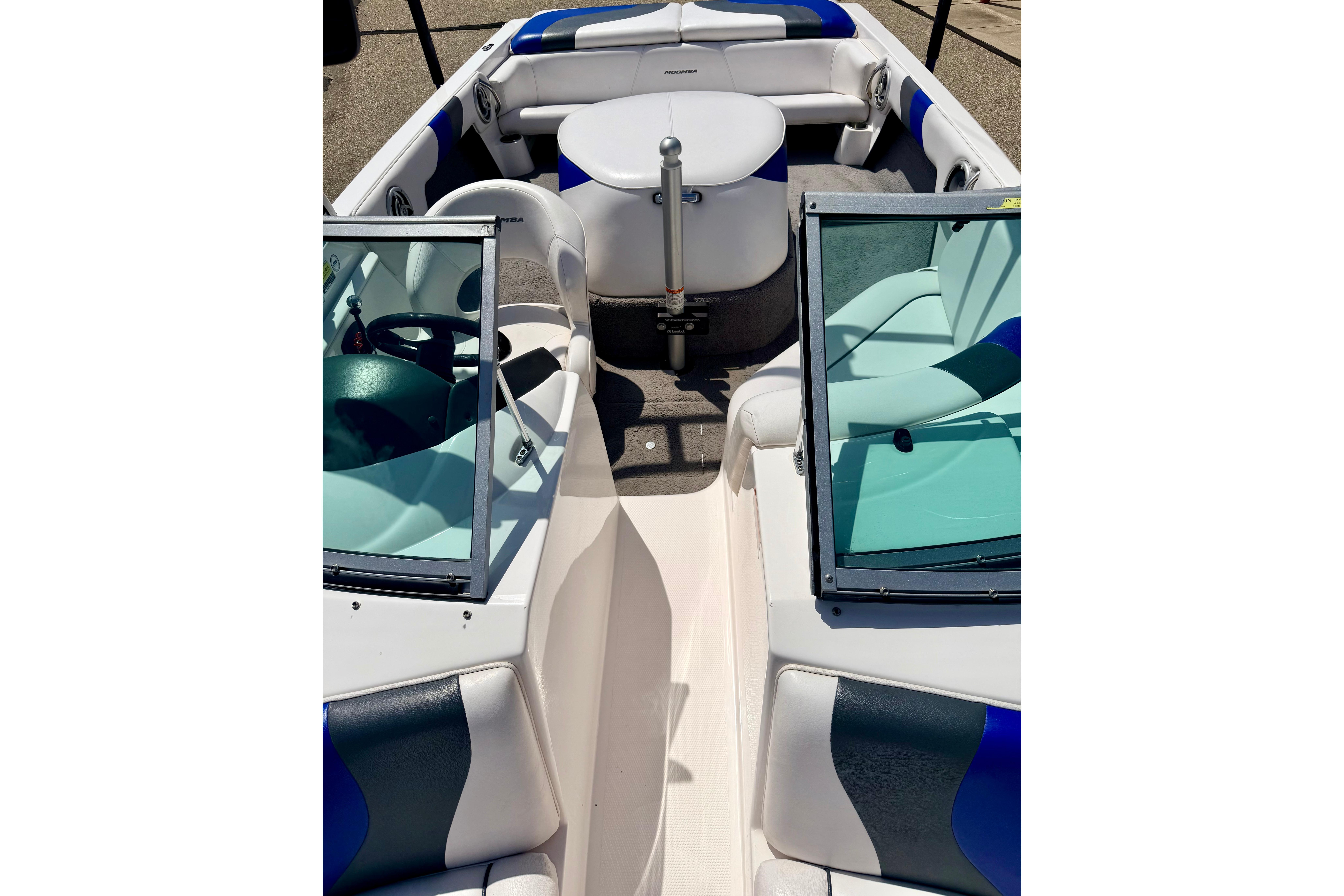 2008 Moomba Outback V boat interior with blue and white seating and windshield.