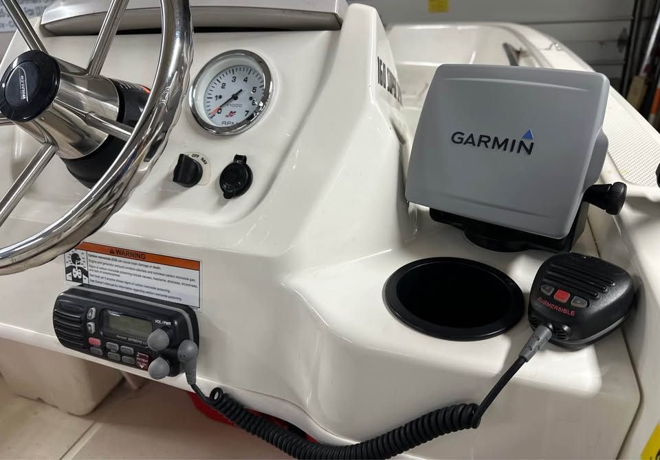 The image shows the cockpit of a 2020 Boston Whaler 160 with Garmin navigation.