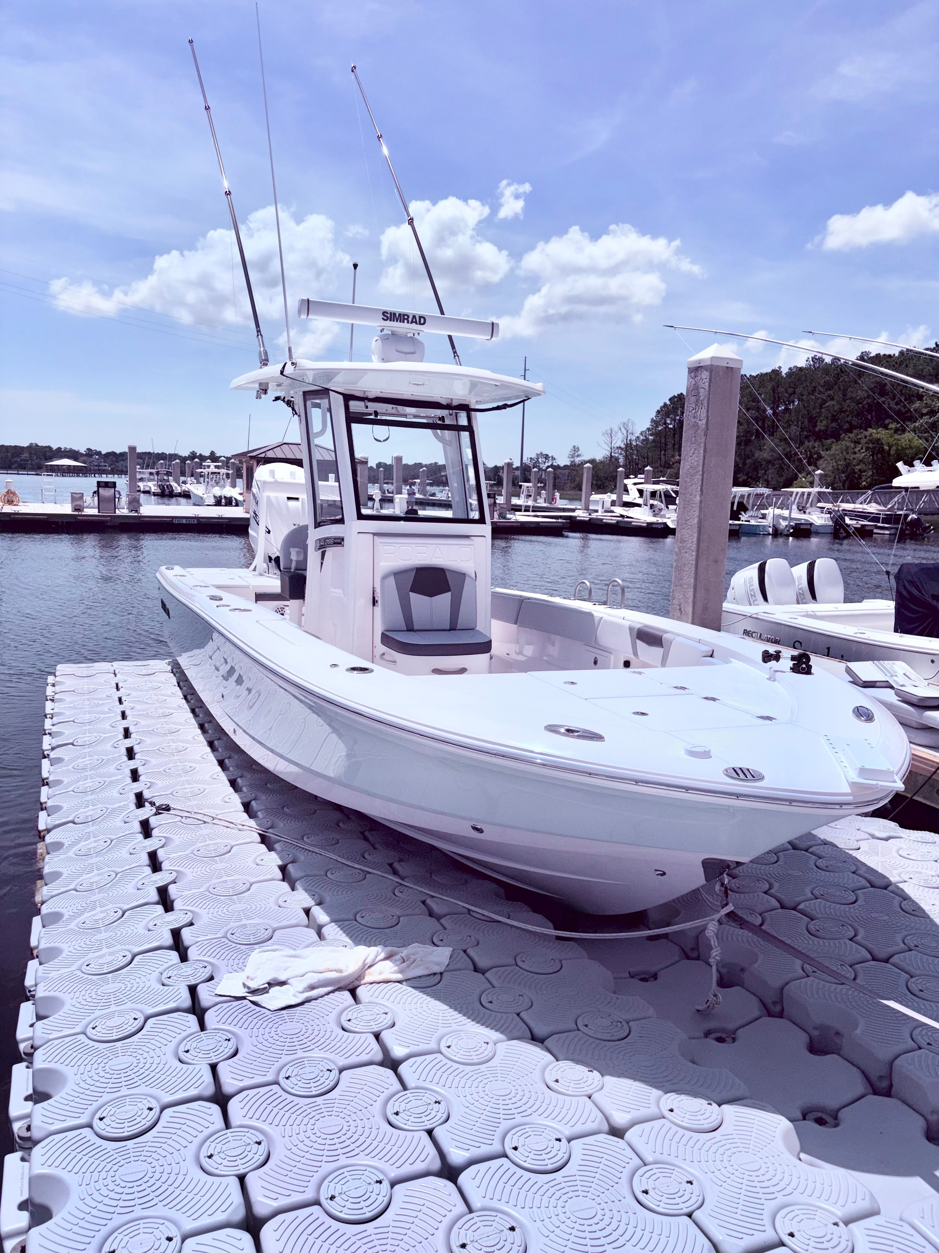 2025 Robalo 266 Cayman boat docked on a sunny day.