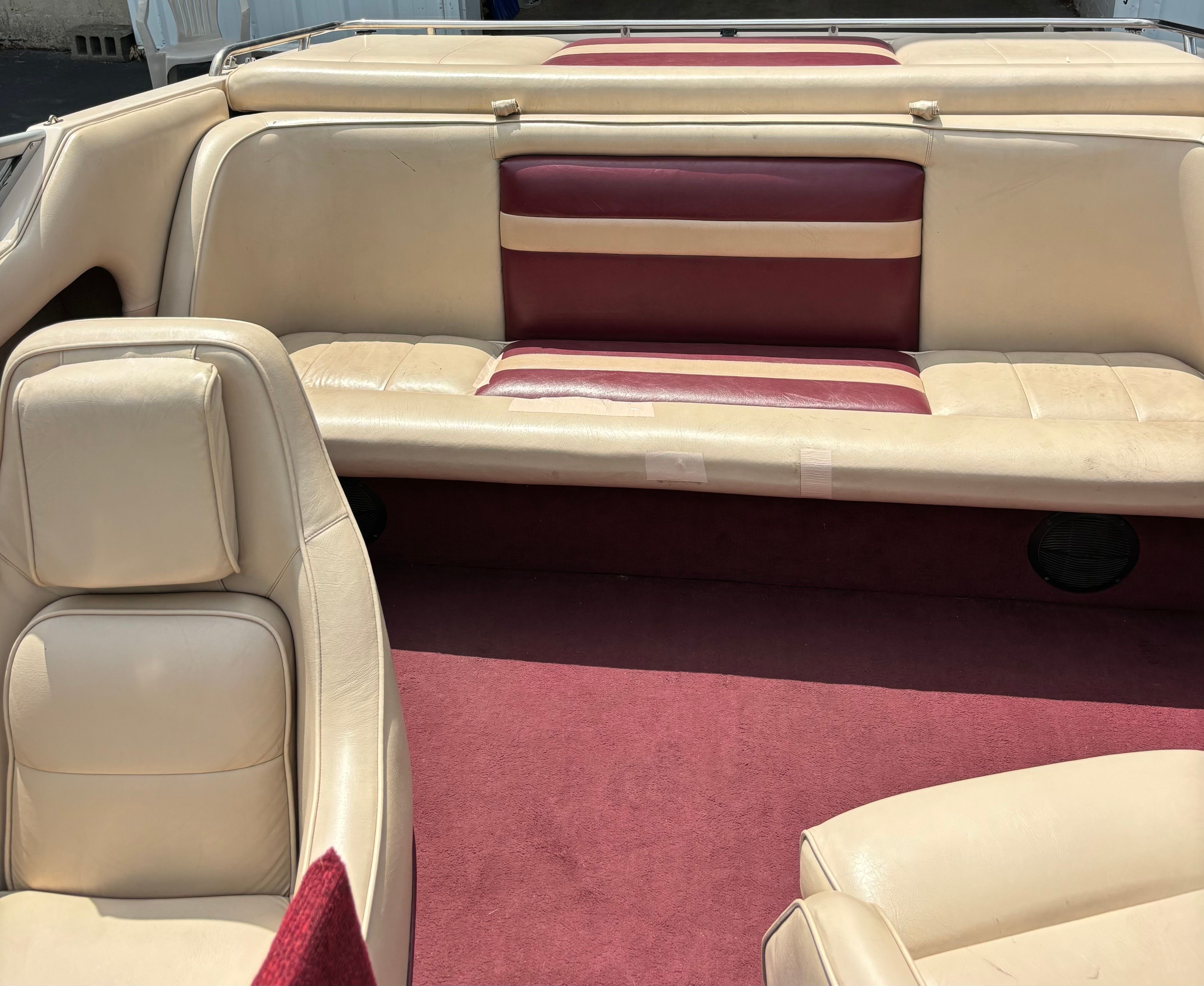 Interior of a 1996 Conquest 2100 boat with beige and red seating.