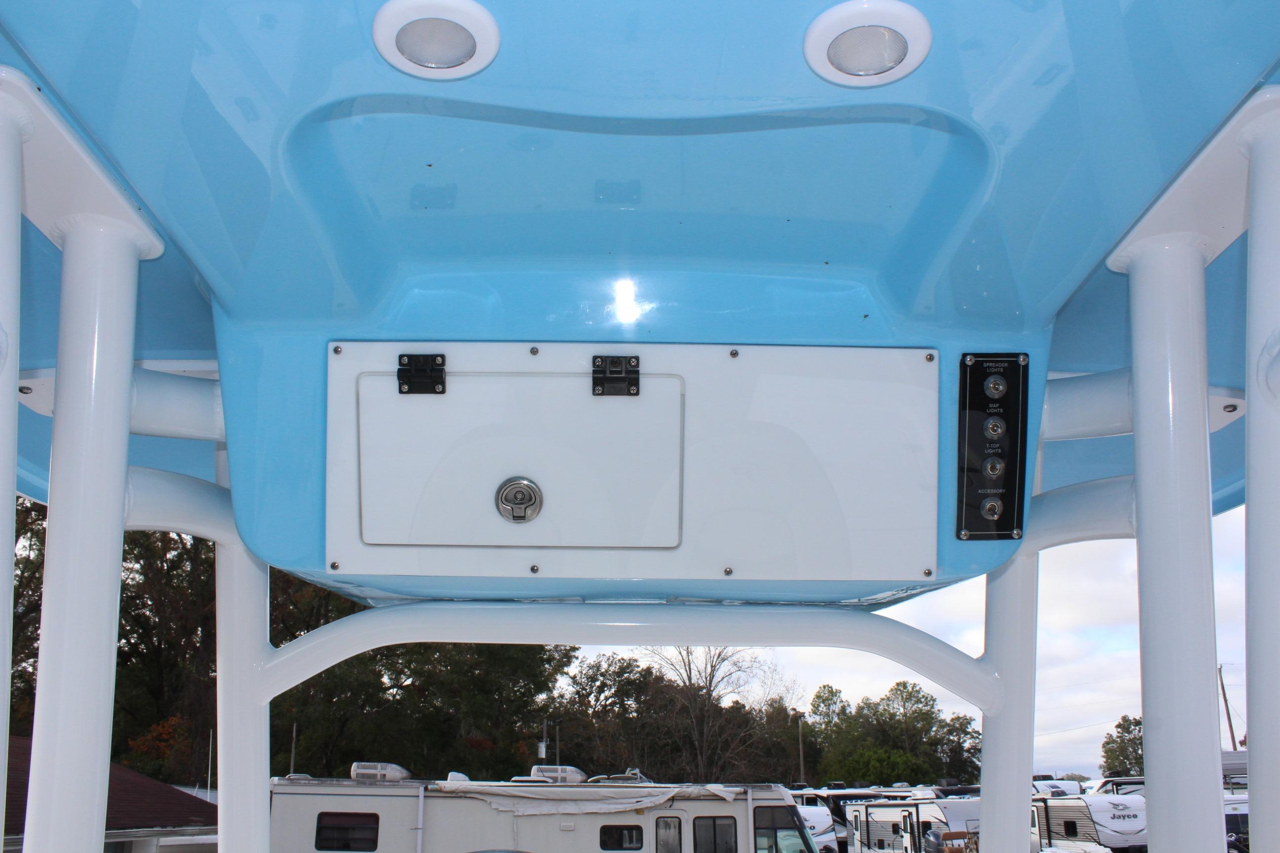 2025 Sea Pro 230 Bay boat's blue T-top with storage compartment and lights.