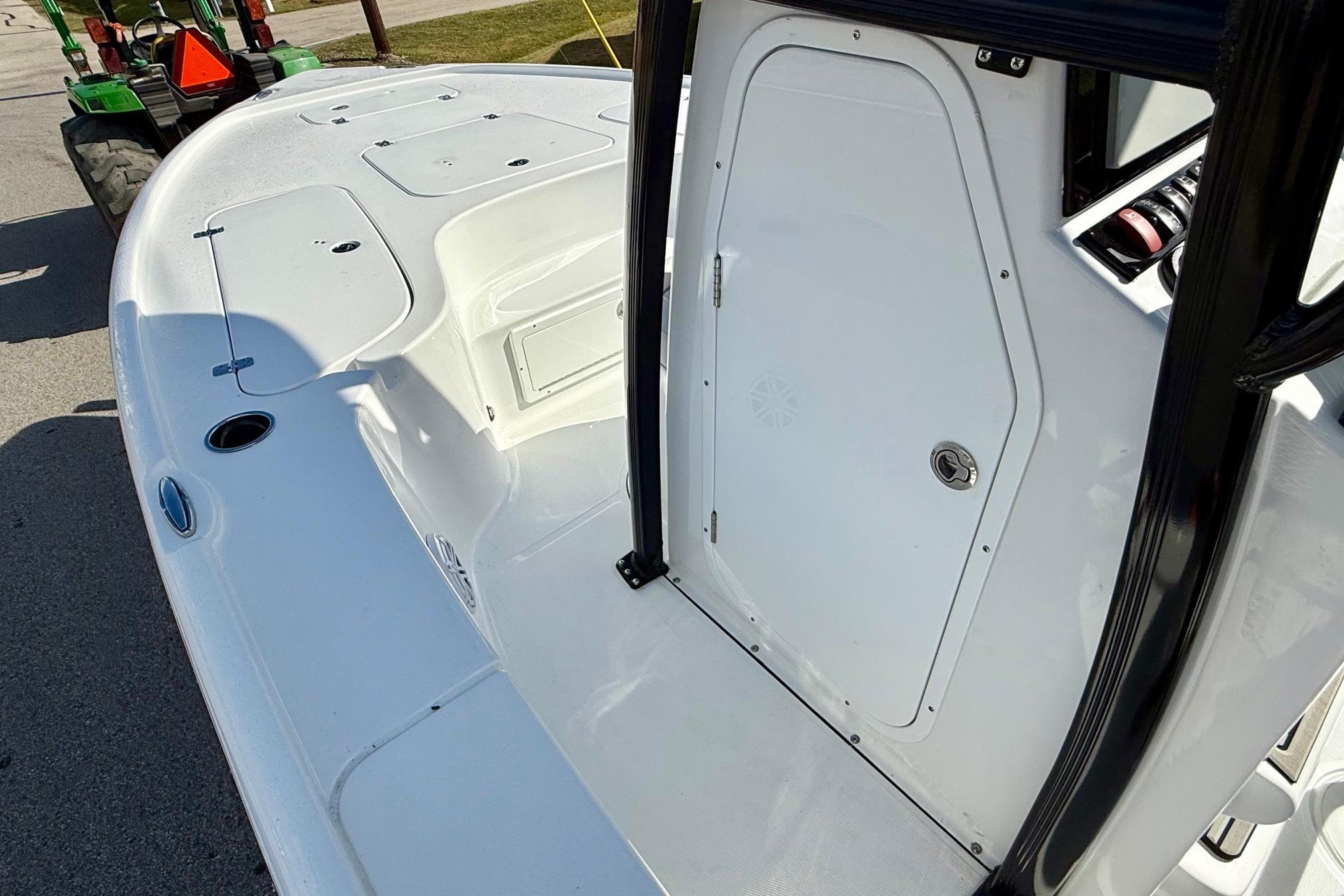 2026 Sea Hunt BX 22 BR boat deck with storage compartments and console door.