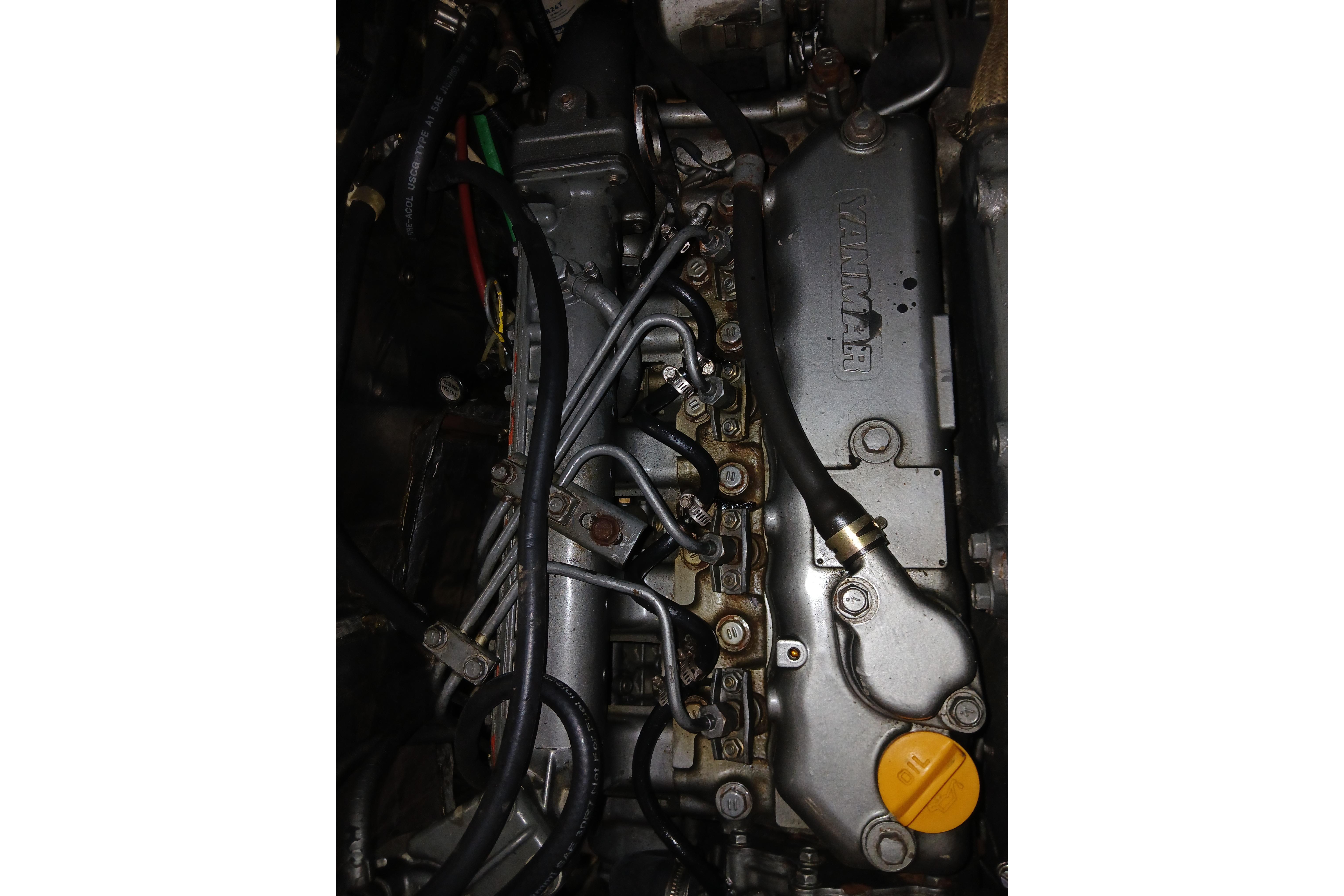 Engine of a 1995 Catalina 42 MkII sailboat, showcasing mechanical components and wiring.