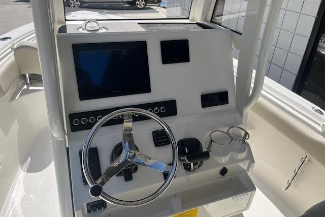 2026 Key West 239 FS boat dashboard with steering wheel and electronic displays.