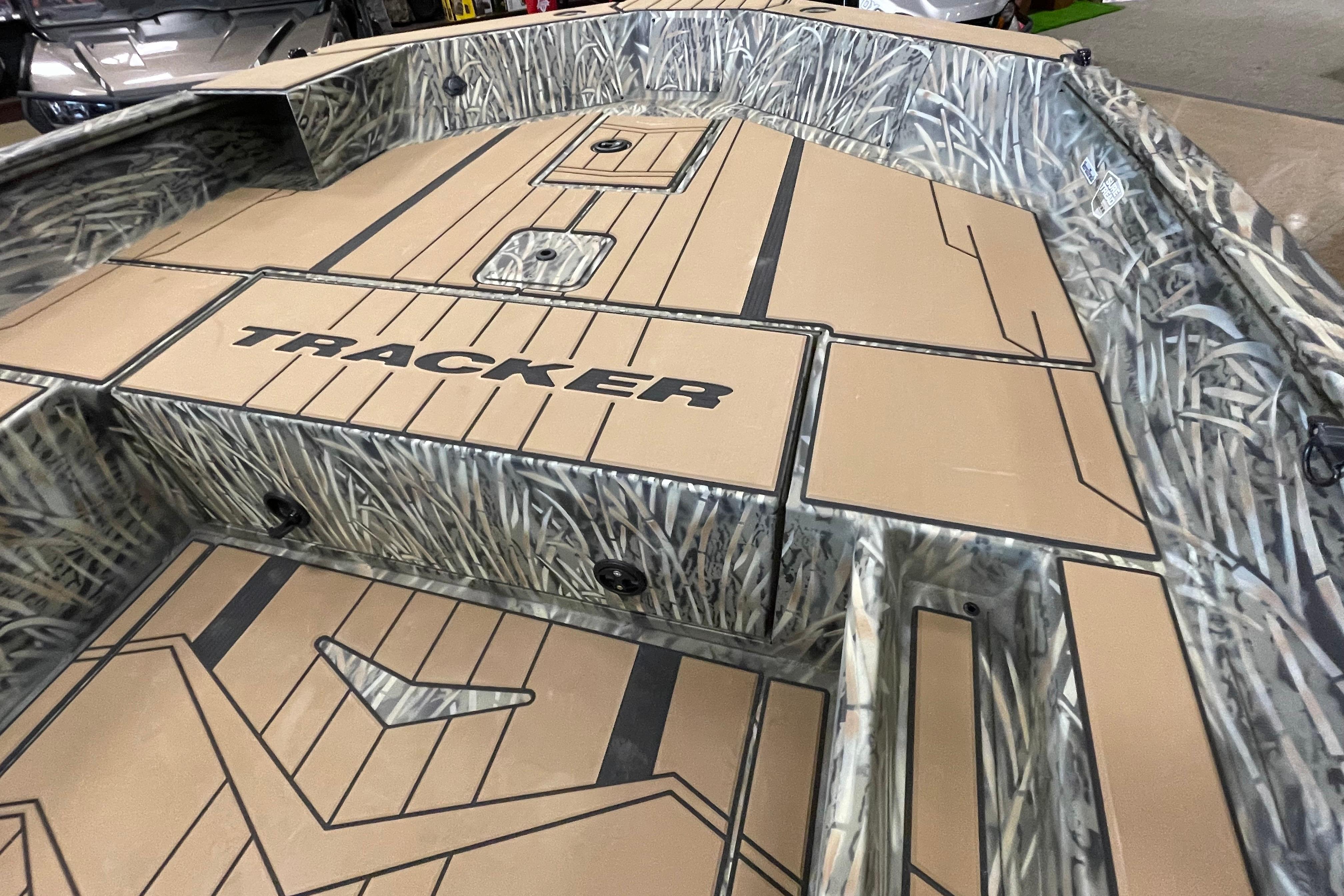 2026 Tracker Grizzly 1756 T Marsh boat interior with camo design and storage compartments.