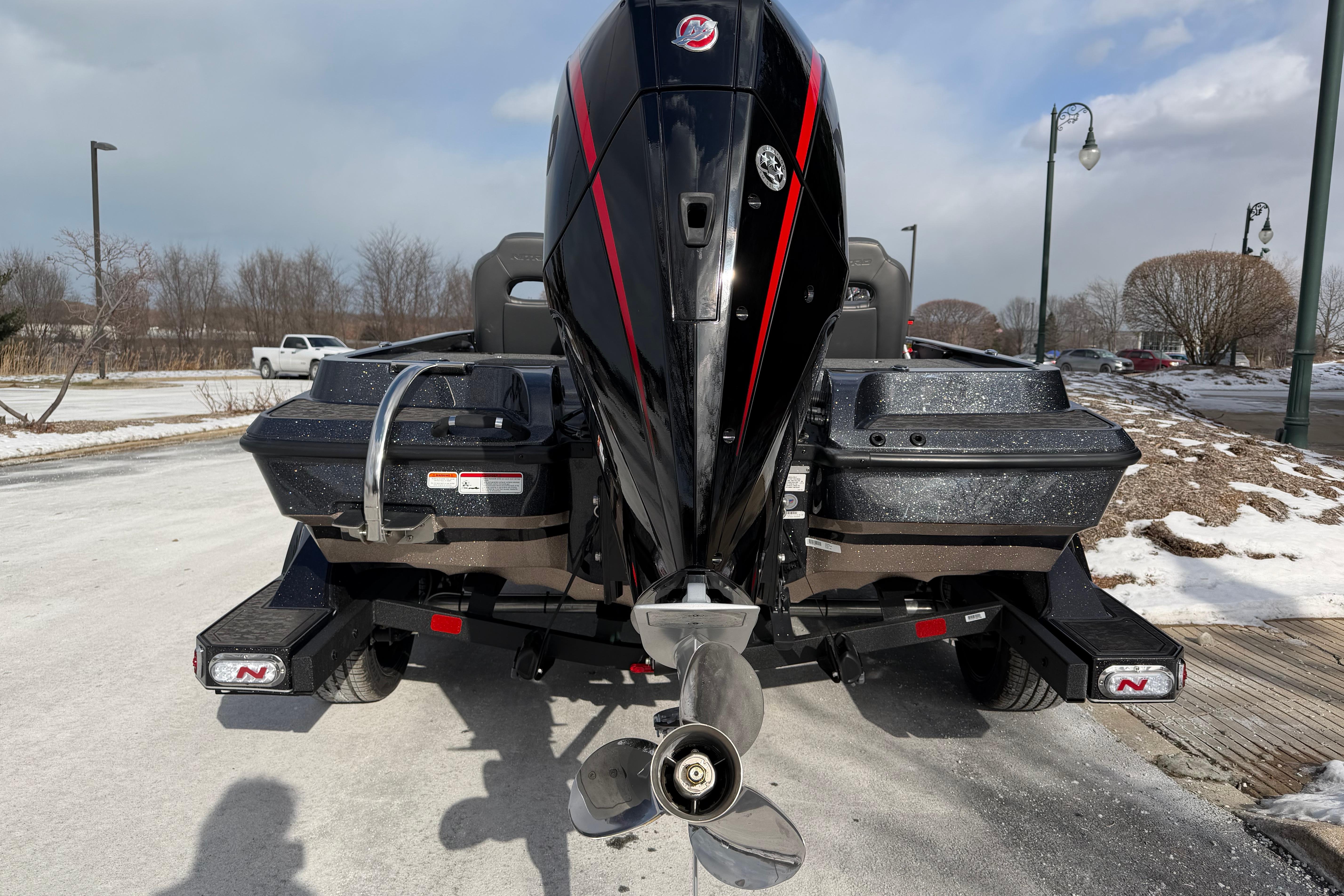 2026 Nitro Z19 XL Pro boat with powerful outboard motor in snowy parking lot.