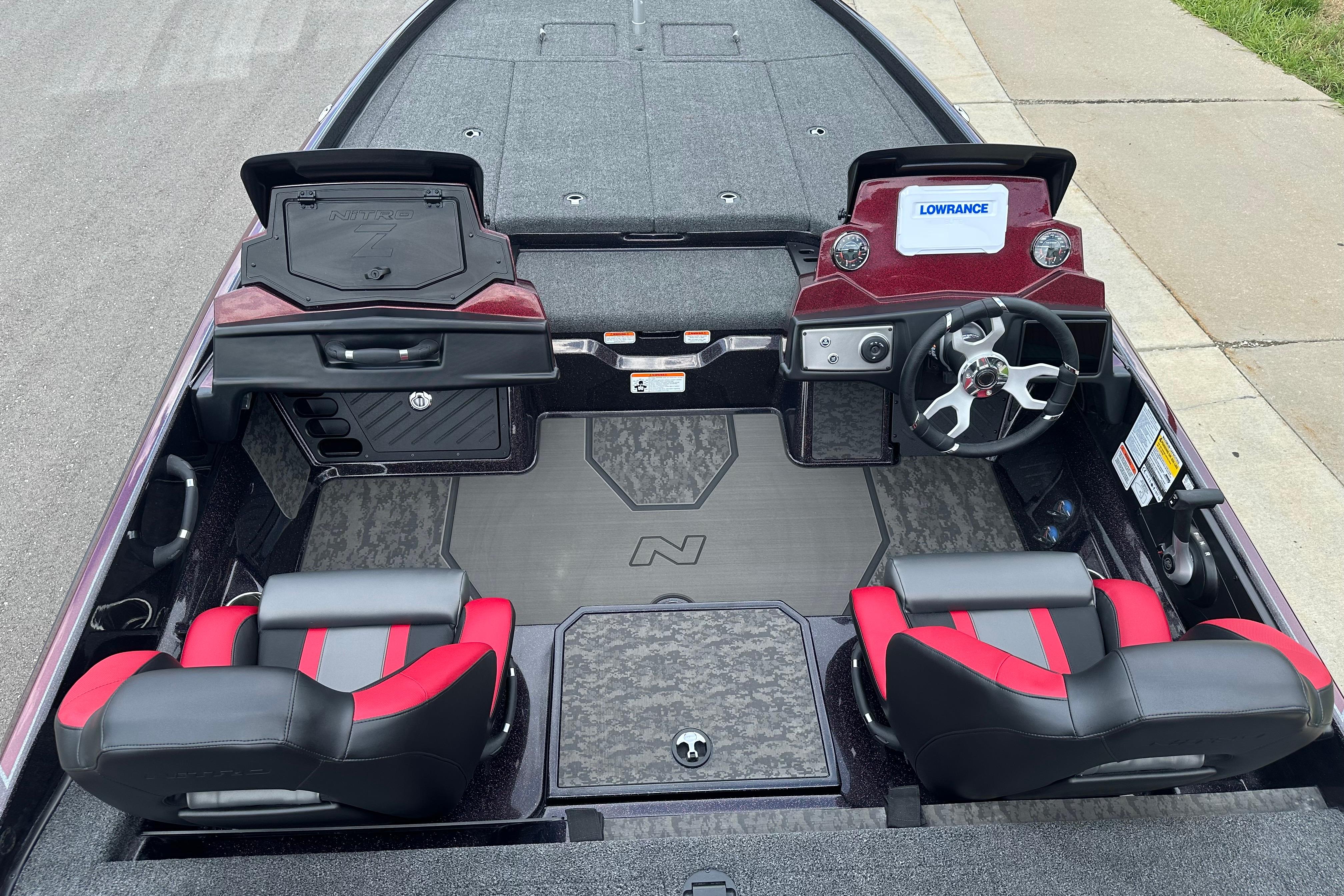 2026 Nitro Z21 XL boat interior with dual seats, steering wheel, and storage compartments.