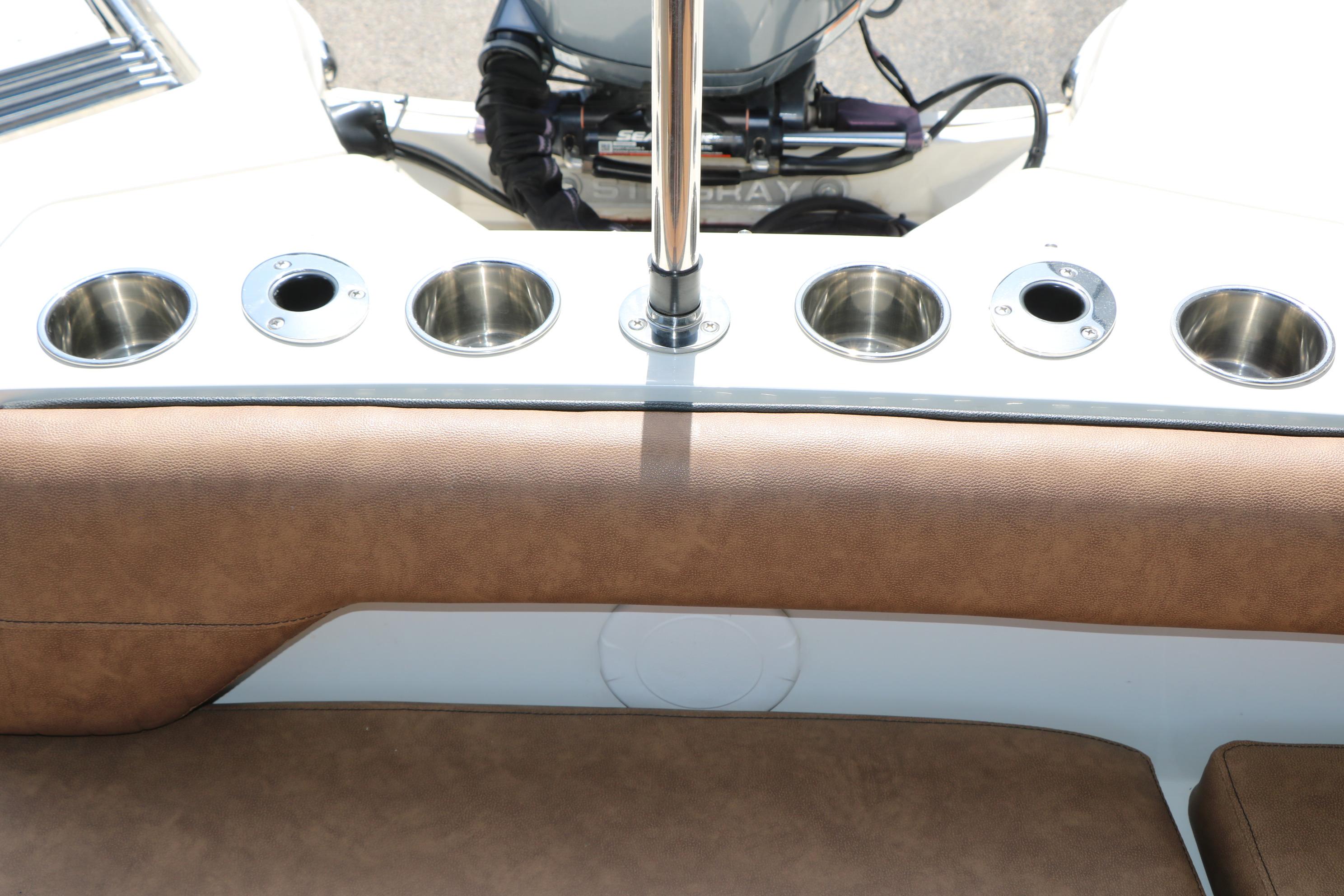2022 Stingray 192 SC boat interior with cup holders and brown seating.