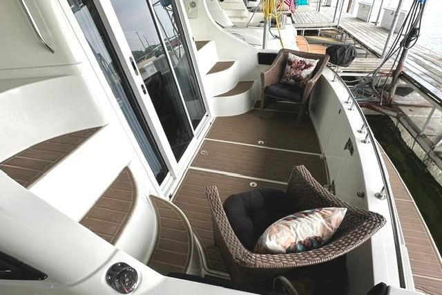 2004 Carver 360 Mariner yacht deck with wicker chairs and wooden flooring.