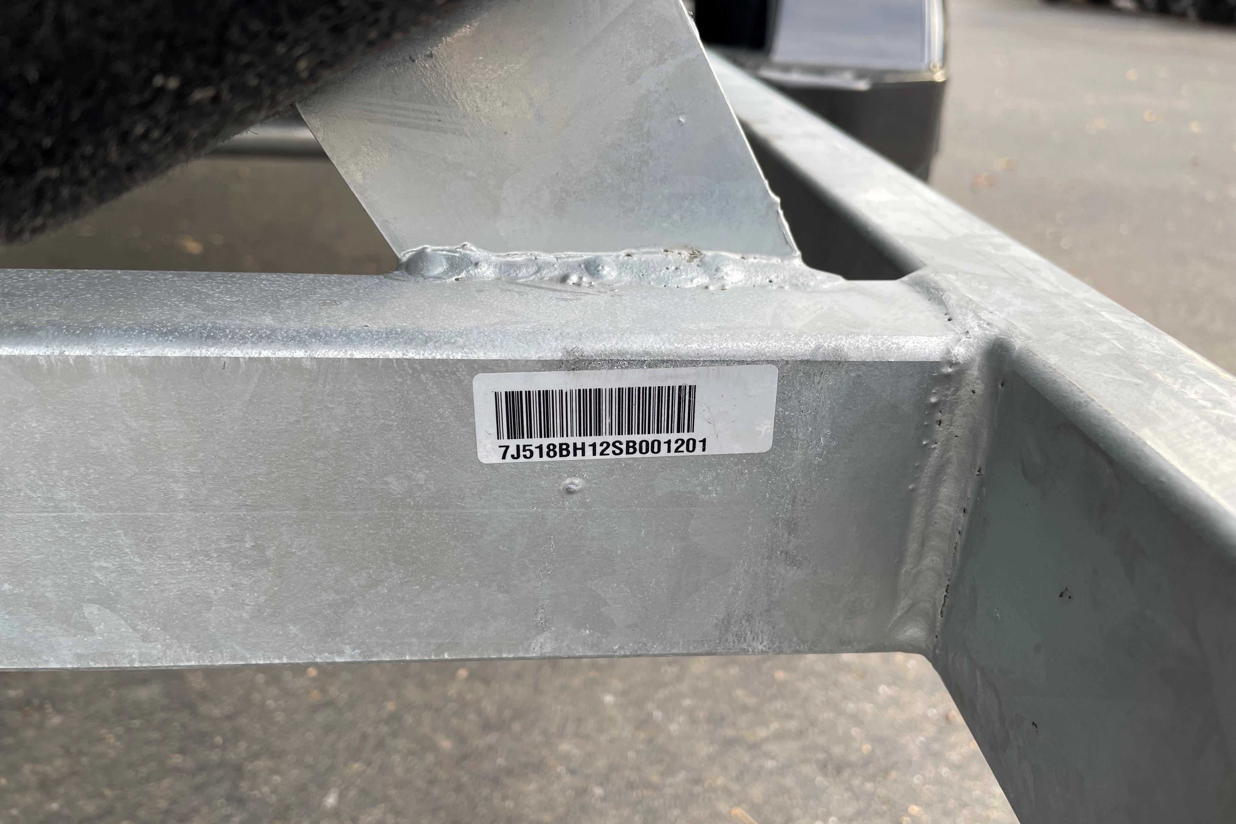 Barcode on metal frame of 2025 Mako Pro Skiff 17 CC boat trailer.