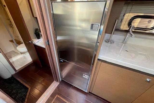 Interior of 2016 Sea Ray Sundancer 510 yacht with stainless steel fridge and modern kitchen amenities.
