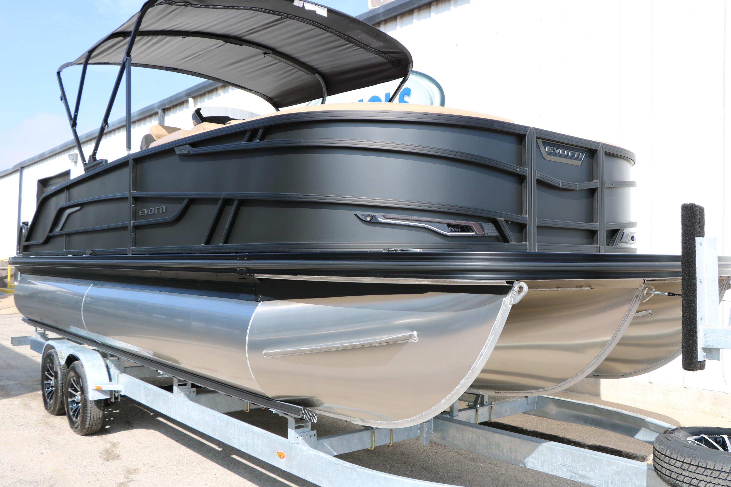 2026 Evotti 723CS pontoon boat on trailer, featuring sleek black design and canopy.