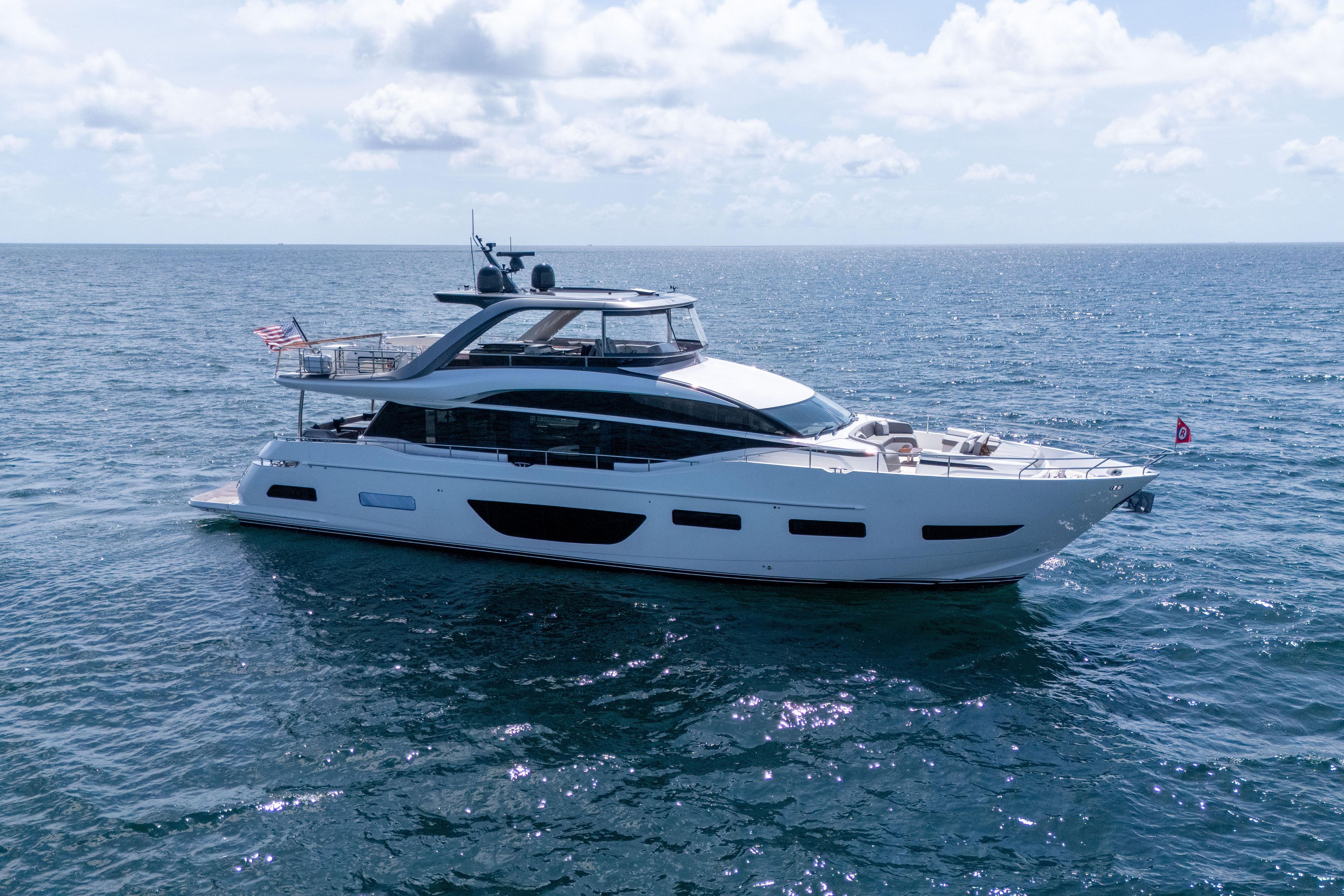 Luxurious 2020 Princess Y85 yacht cruising on open sea under clear skies.