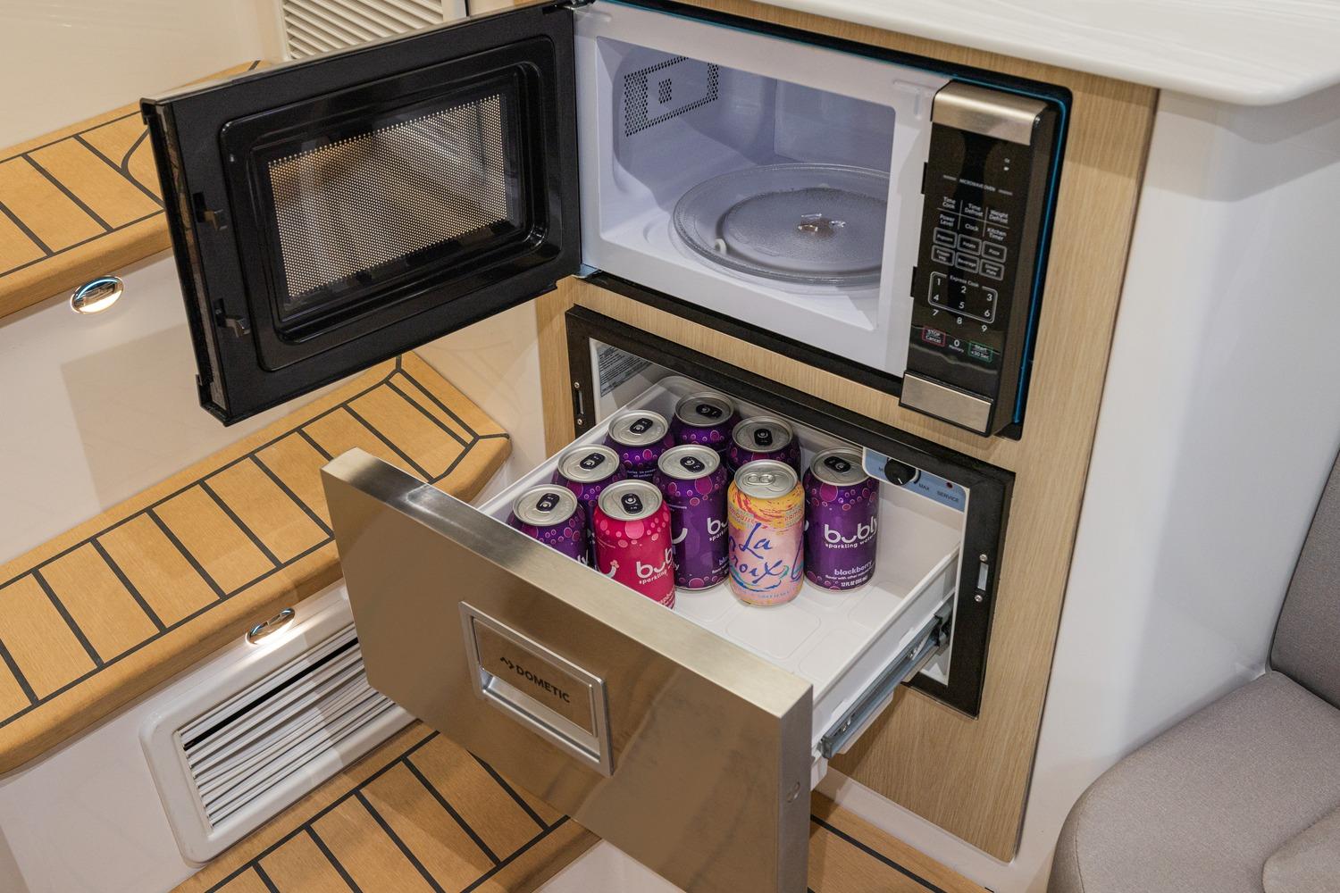 Interior of 2026 Hurricane SunDeck 3200 OB with microwave and beverage storage.