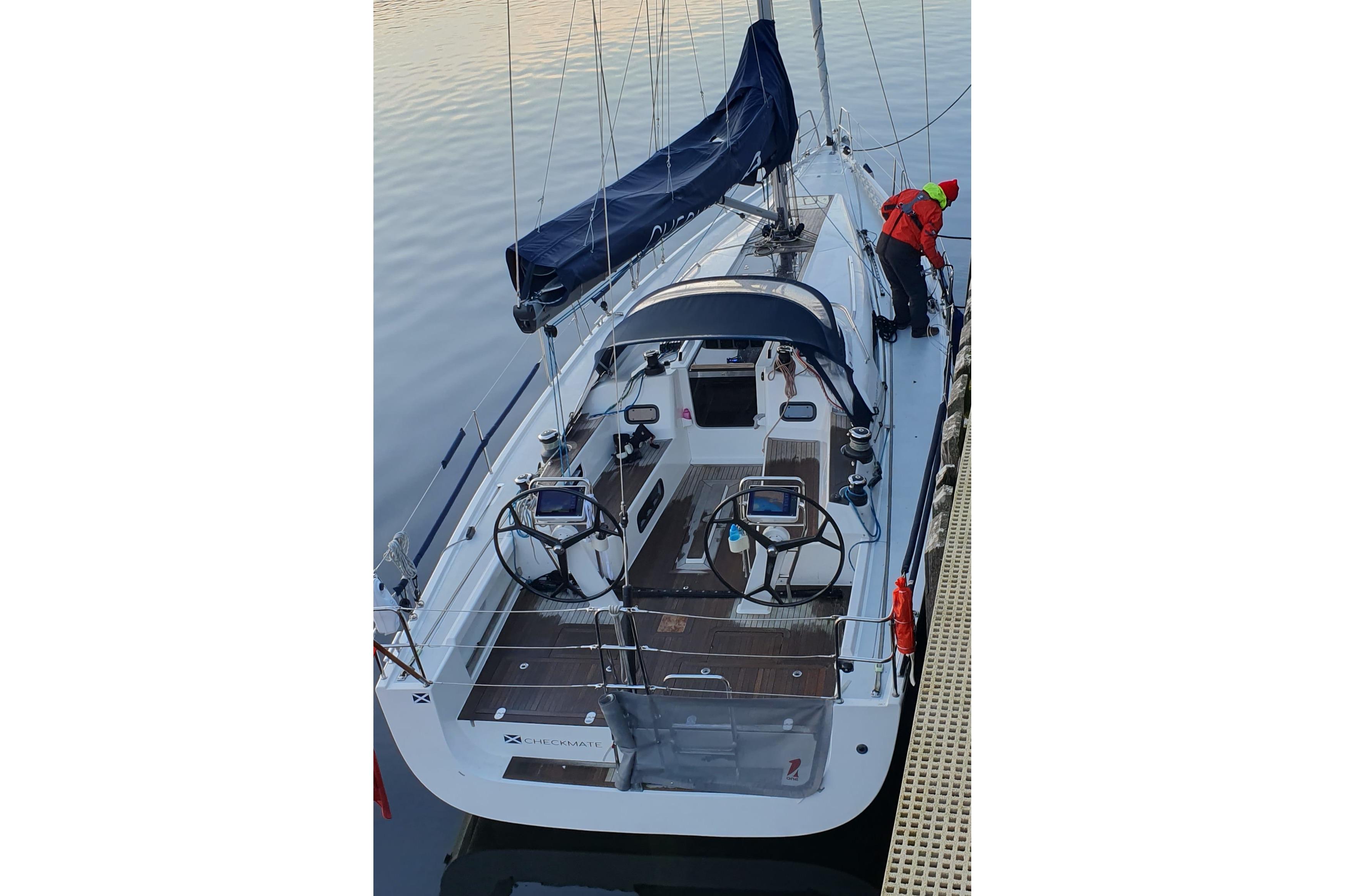 2018 Arcona 435 sailboat docked, featuring dual steering wheels and a sleek design.