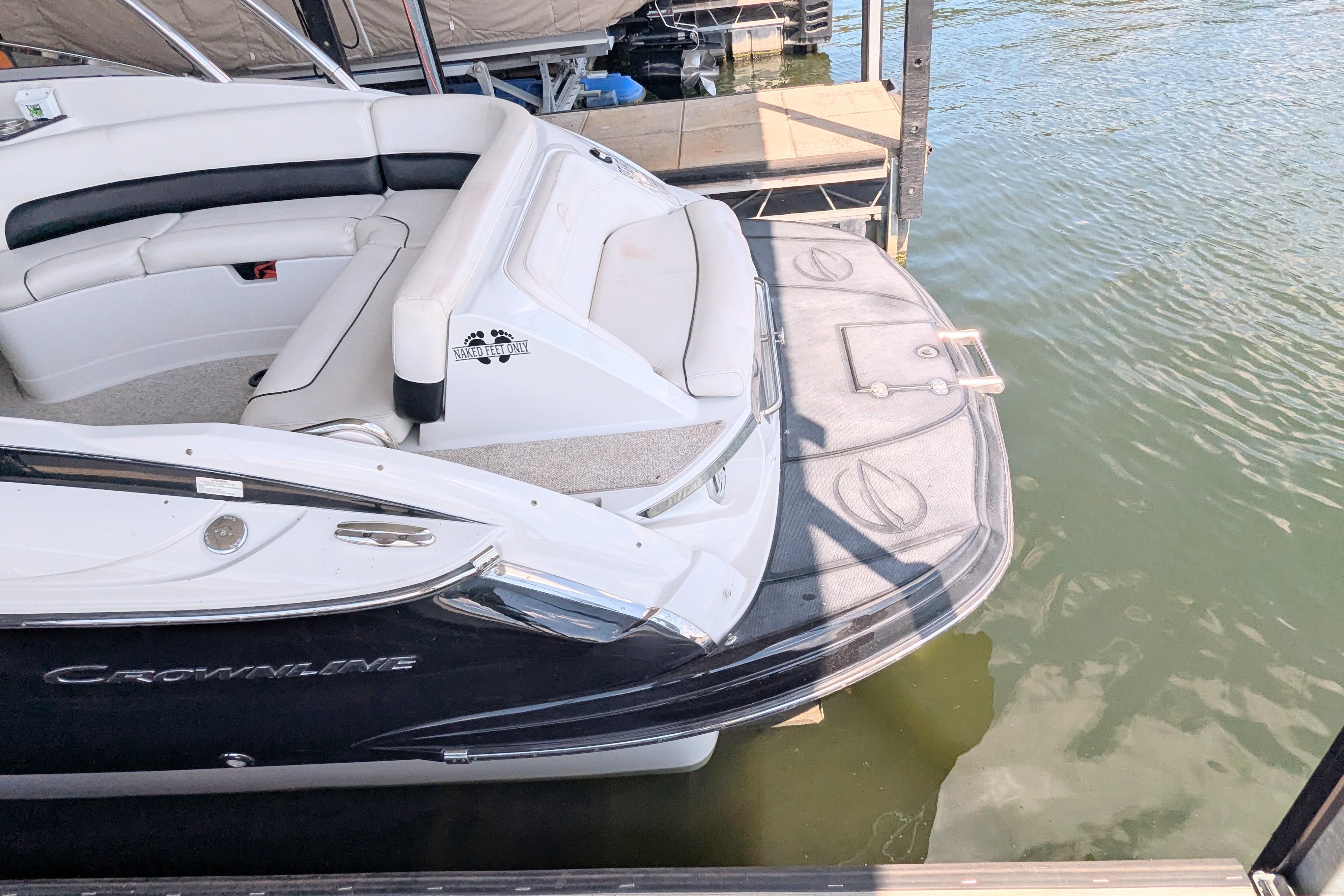 2008 Crownline 300 LS boat docked, featuring sleek design and comfortable seating.