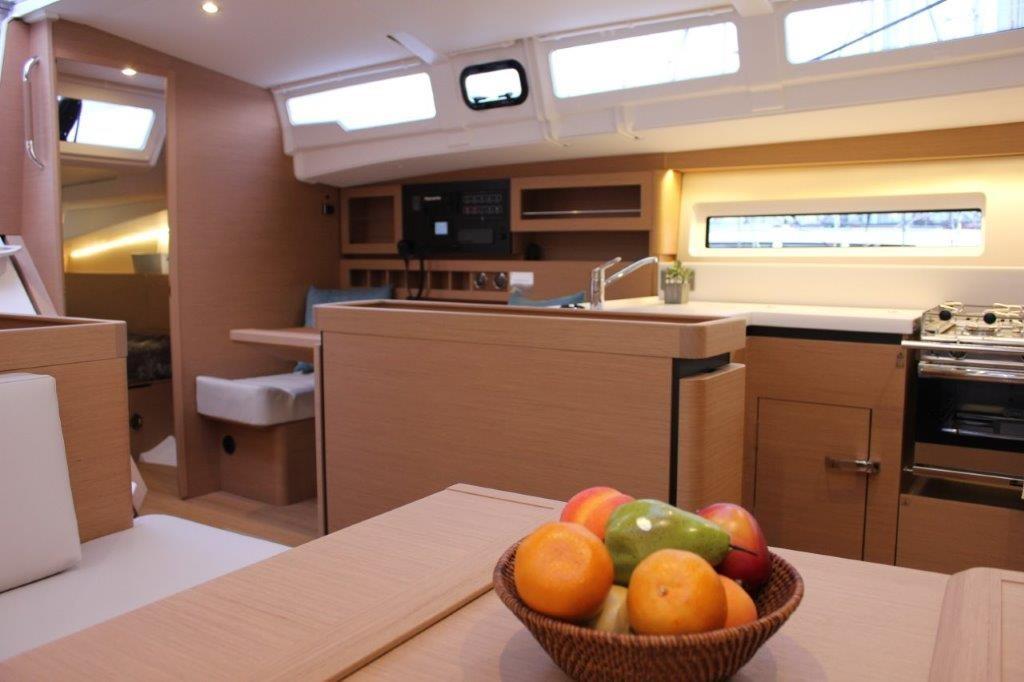 Modern interior of 2024 Jeanneau Sun Odyssey 490 yacht with fruit basket.