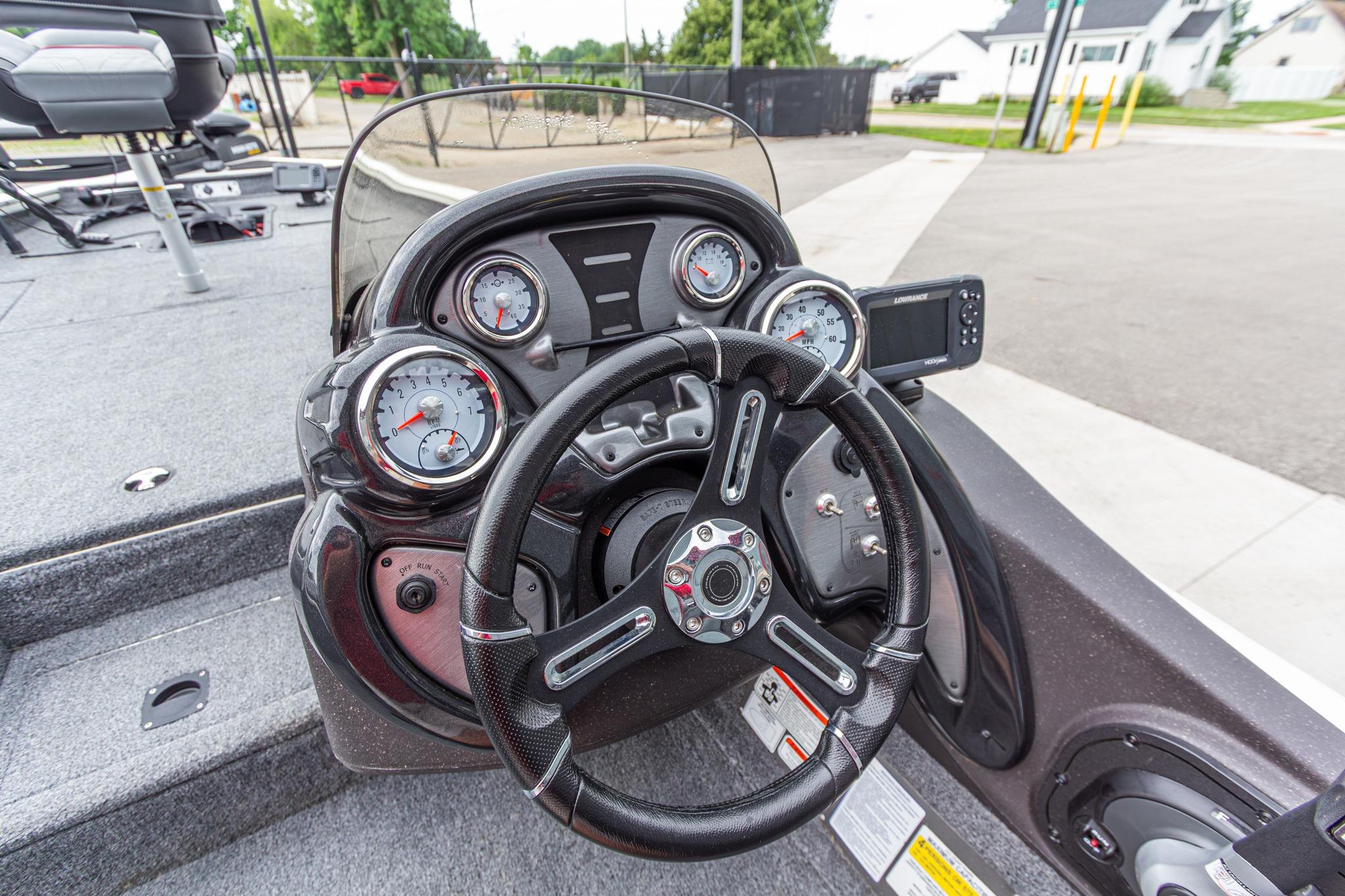 2023 Tracker Pro Team 190 TX boat dashboard with steering wheel and gauges.