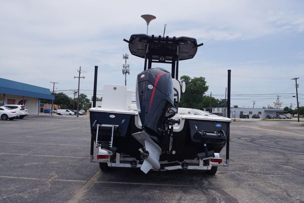 2027 Tidewater 2500 Carolina Bay boat with outboard motor in parking lot.