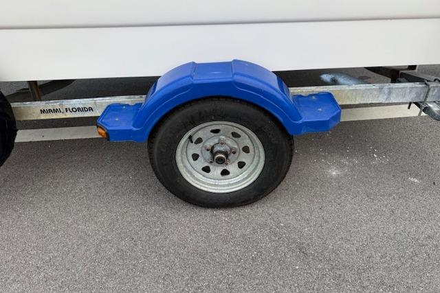 Trailer wheel with blue fender for 2016 Boston Whaler 150 Montauk in Miami, Florida.