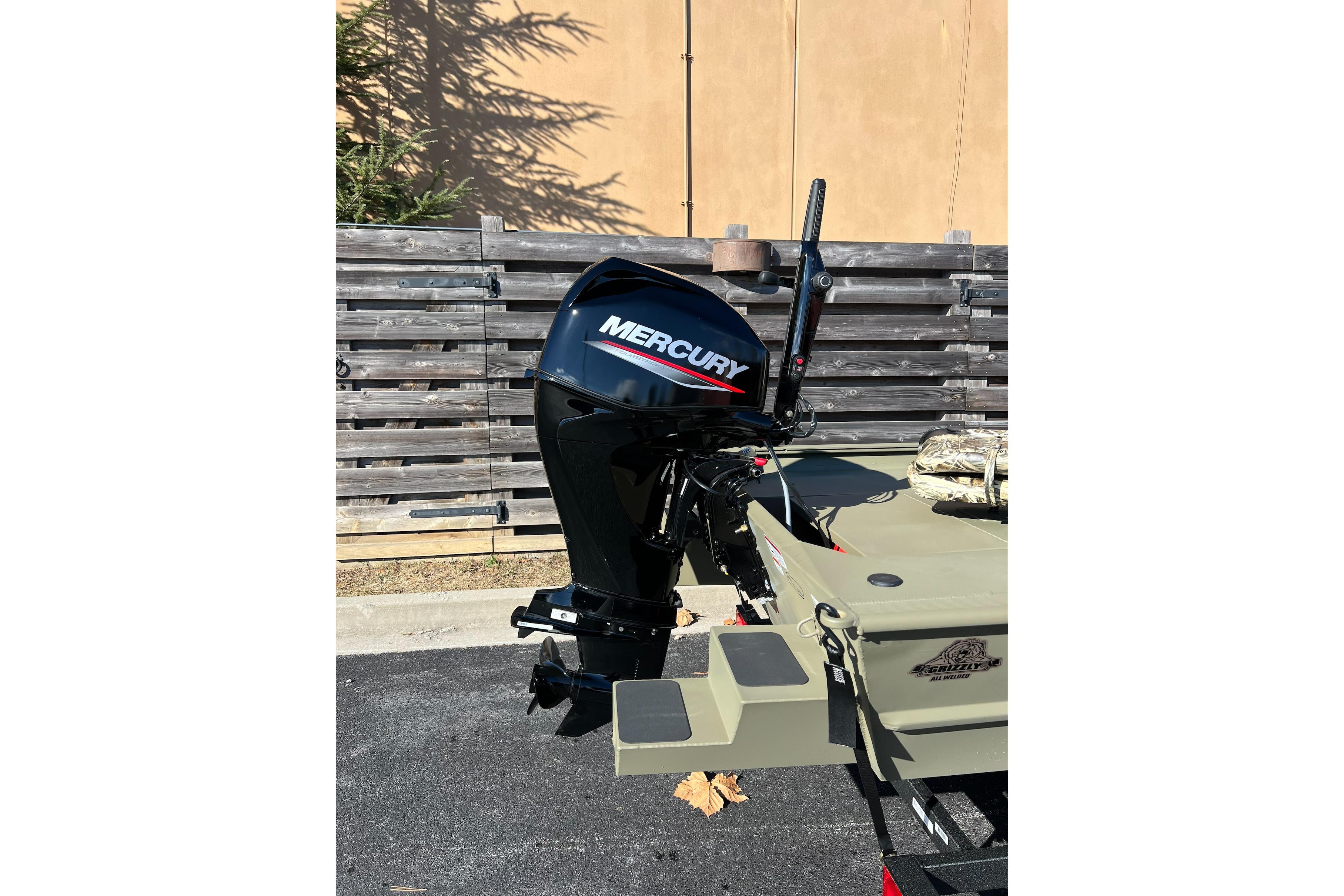 2026 Tracker Grizzly 1654 T Sportsman boat with Mercury outboard motor.