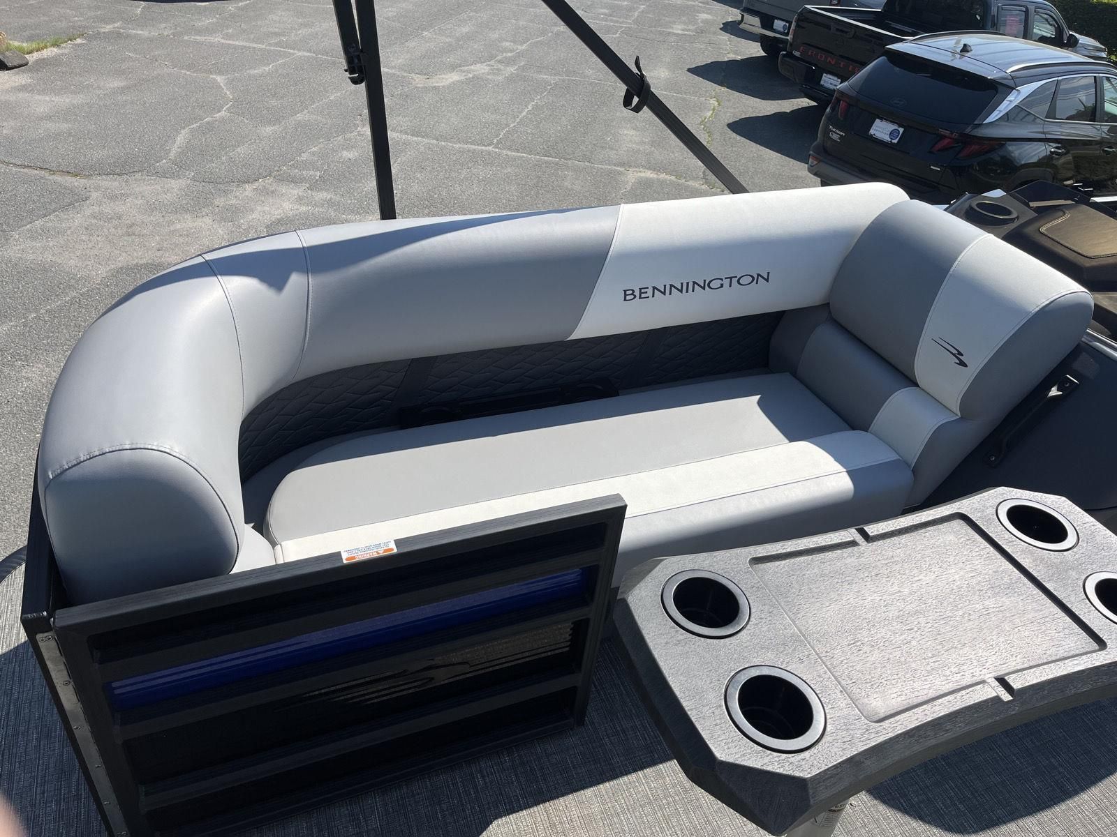 The image shows a gray seating area on a Bennington S20 boat, surrounded by cup holders.