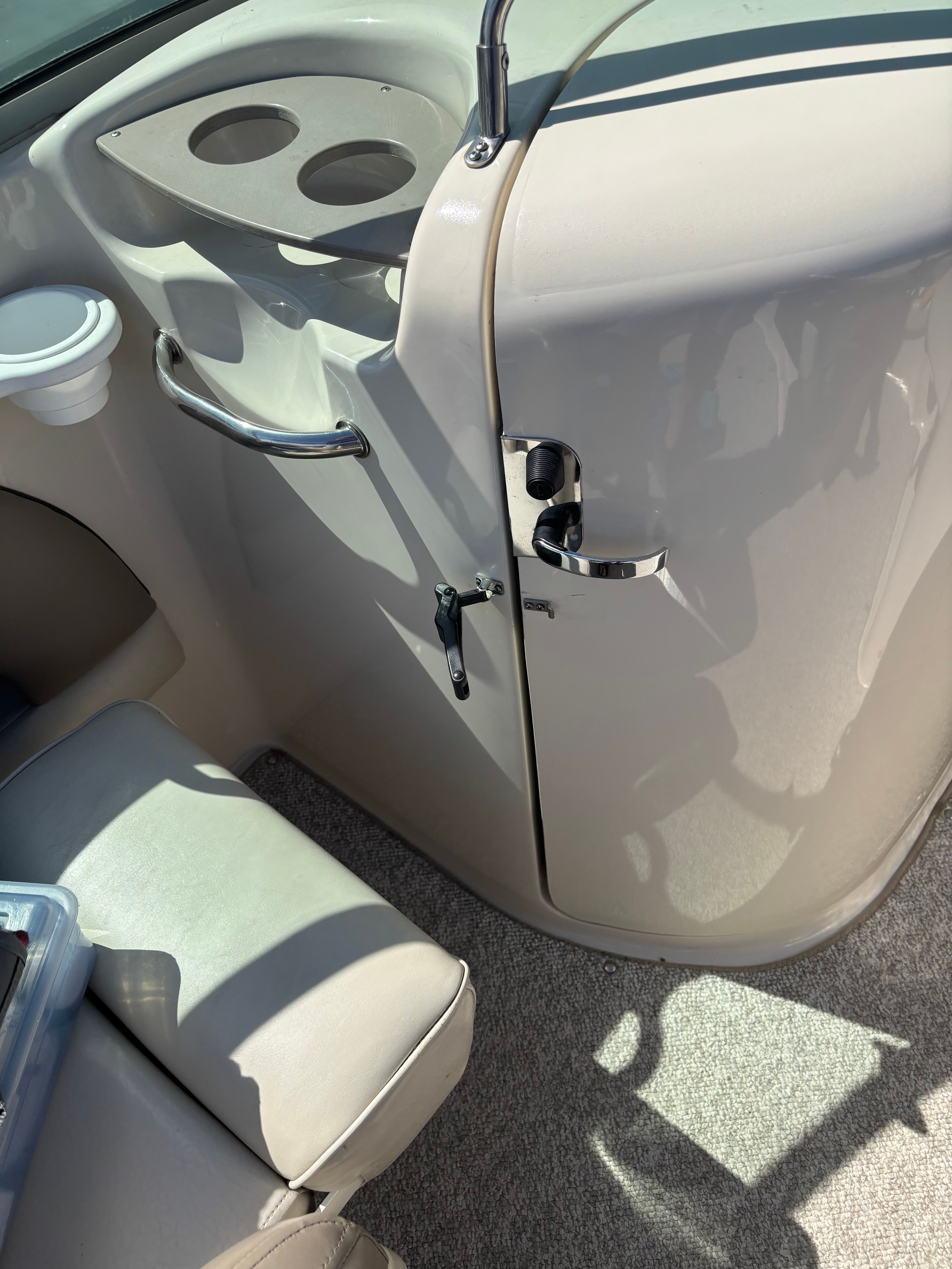 Interior view of a Sea Ray 220 Sundeck boat with seating and dashboard.