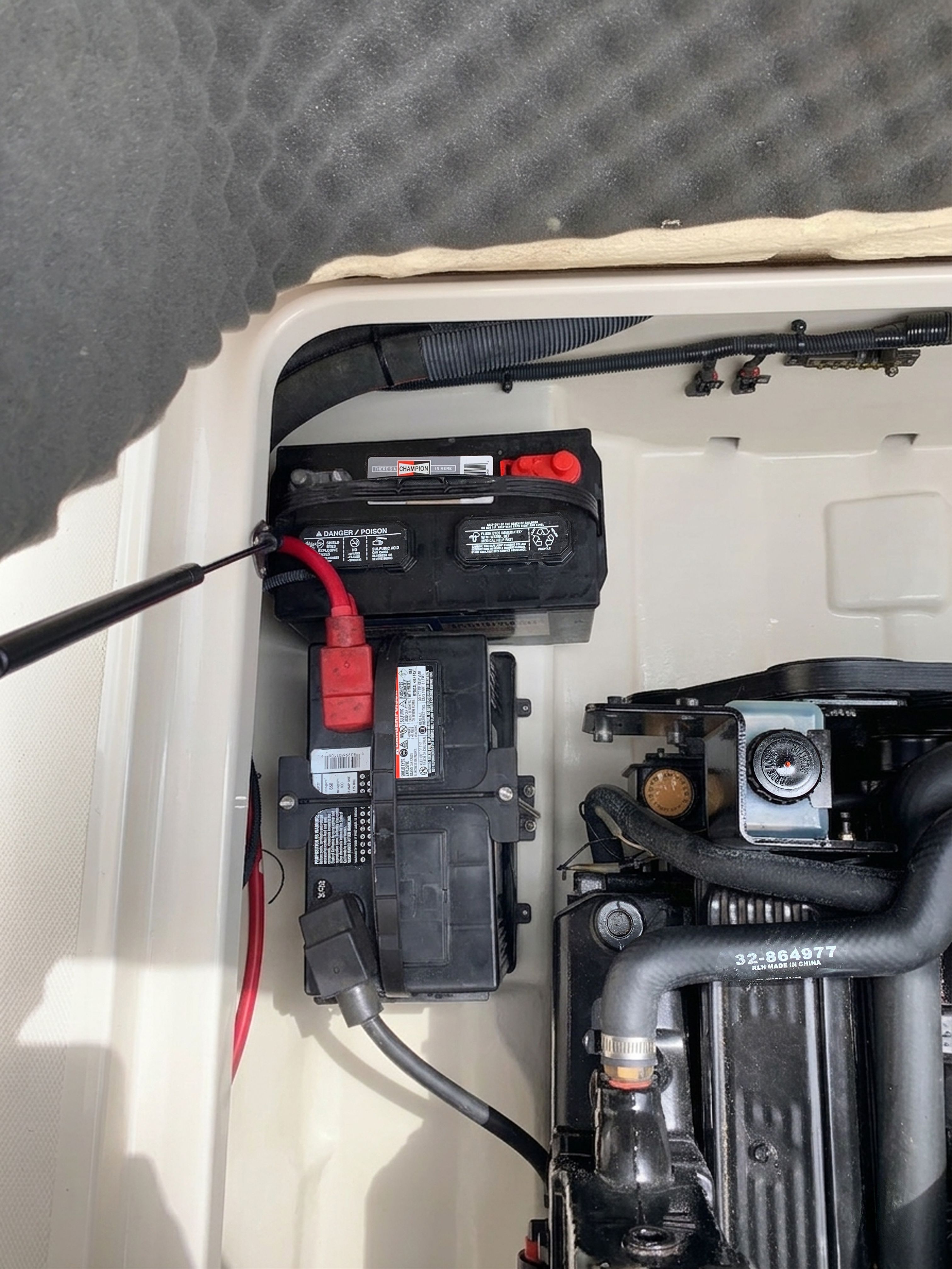 Engine compartment of a 2006 Sea Ray 215 Weekender with battery.