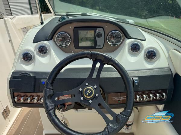 Dashboard of a 2008 Sea Ray 270 SLX boat with steering wheel and gauges.