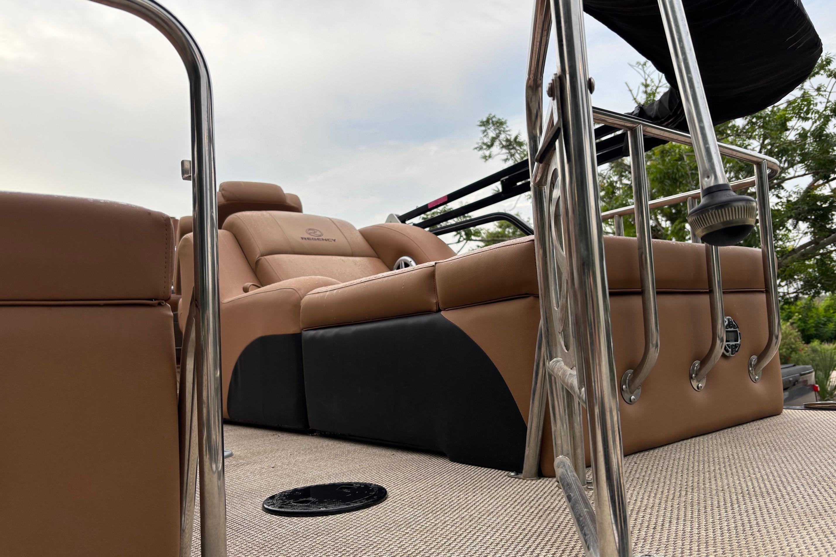 2018 Regency 254 LE3 Sport boat interior with tan seating and metal railings.