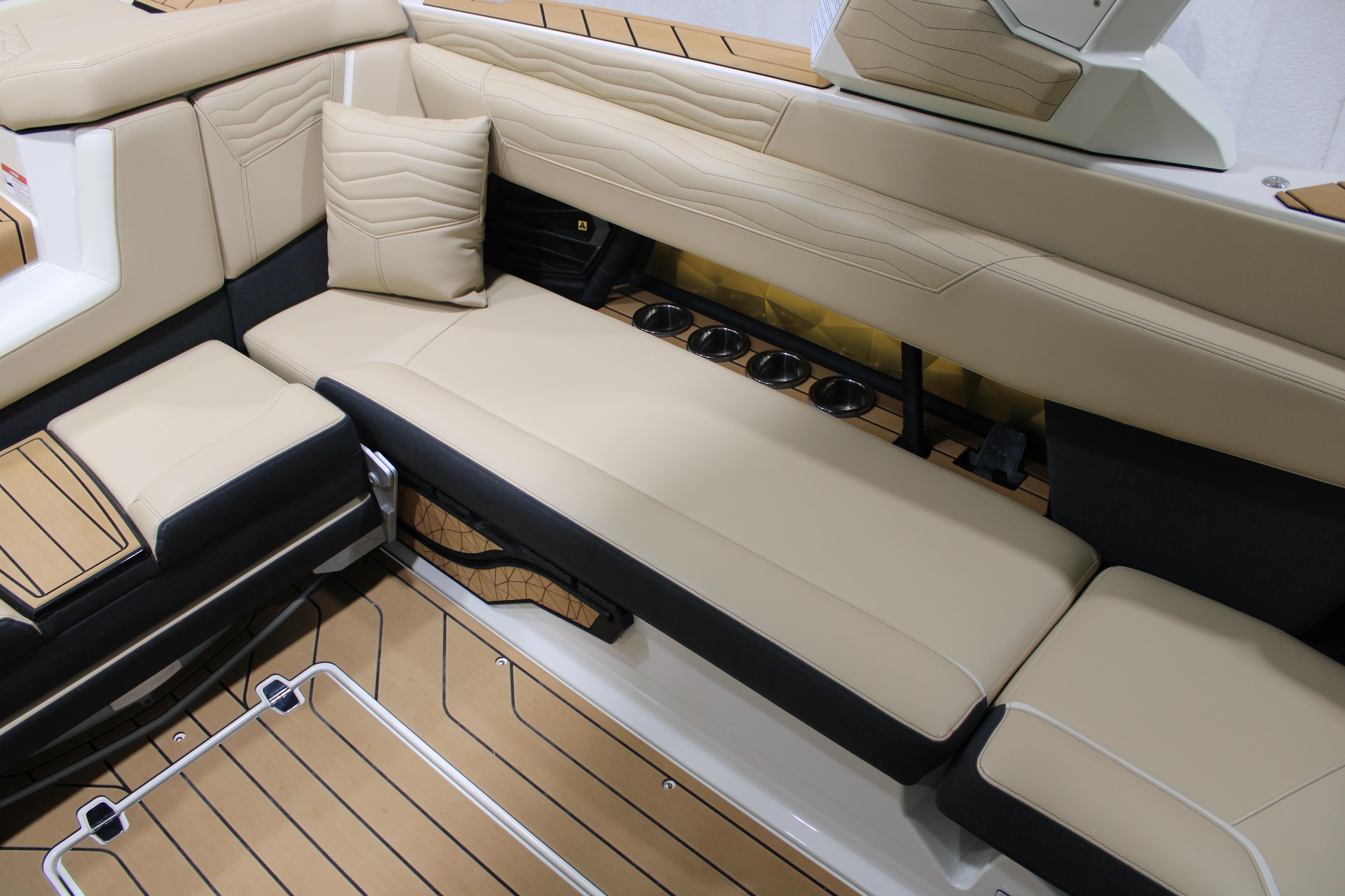 Luxurious interior seating of 2025 Nautique Super Air Nautique G25 boat with beige upholstery.