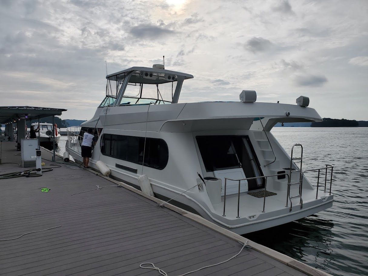 1996 Blue Water motor yacht docked under cloudy sky.