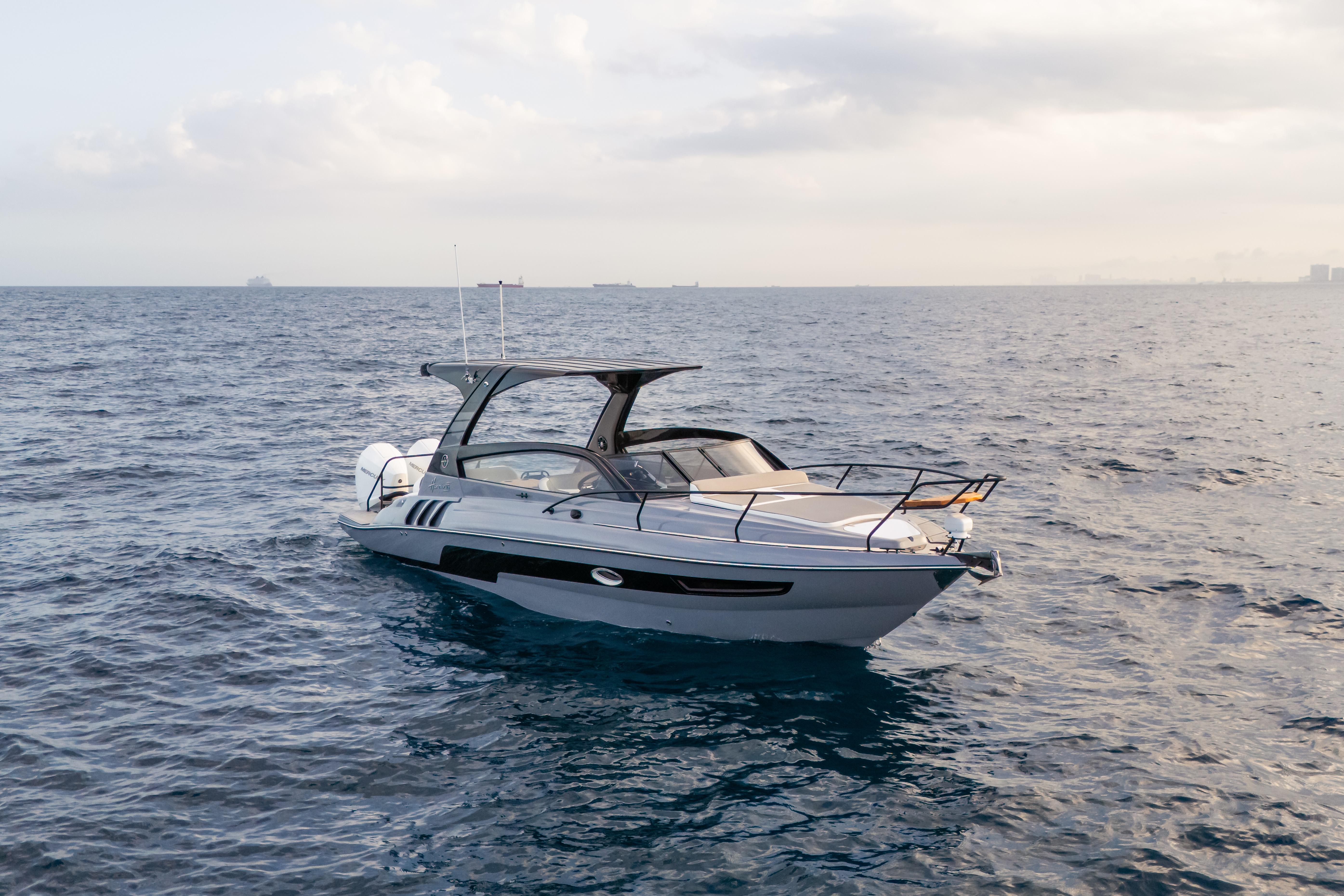 Modern Hanover 305 yacht cruising on open sea, 2026 model, under cloudy sky.