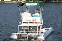 Two people on a 2026 Aqua Cycle 15 pedal boat on a lake.