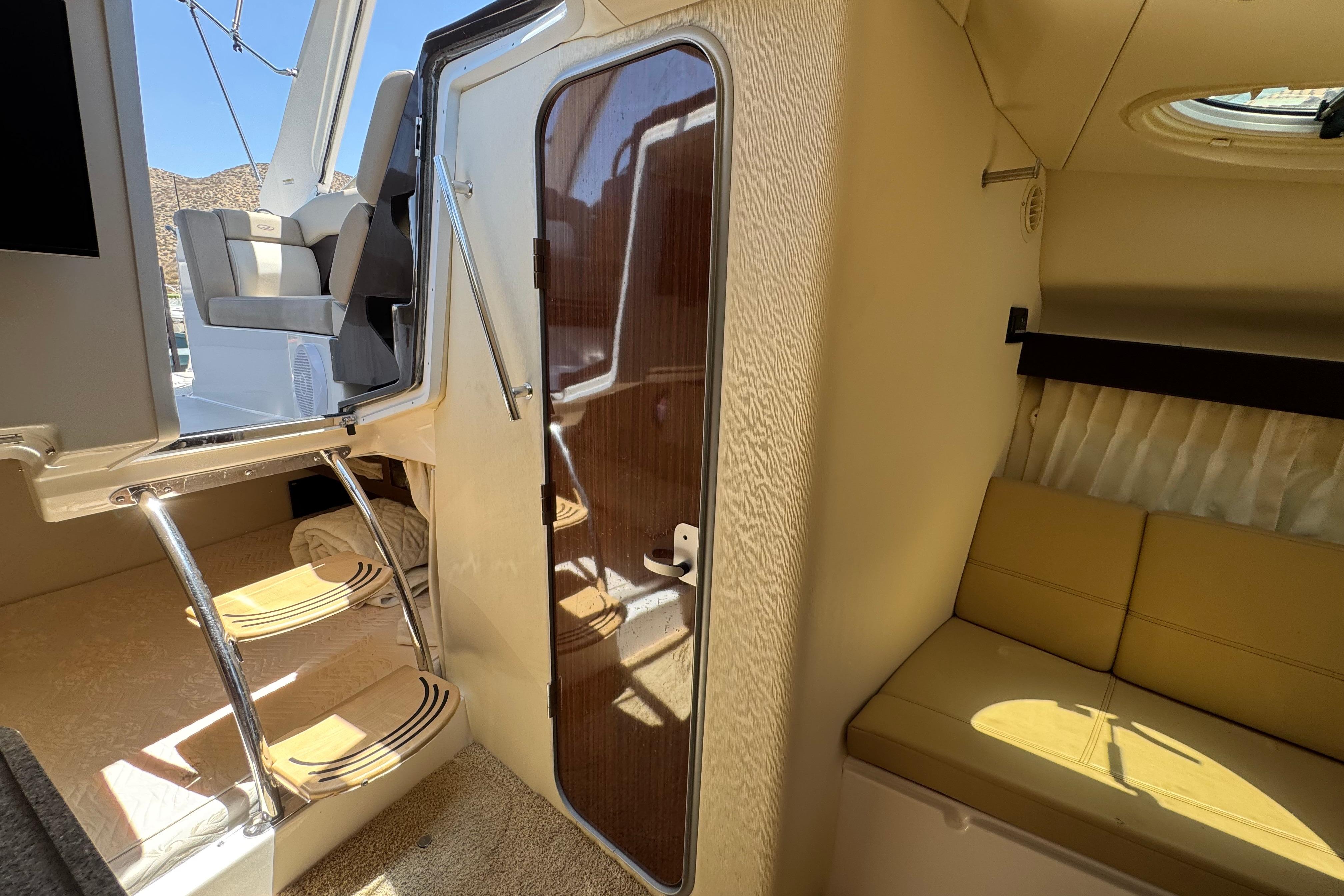 Interior view of a 2013 Regal 28 Express boat, featuring seating and stairs.