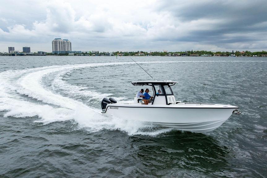 2027 Reef Runner 280 boat cruising on open water with city skyline in background.