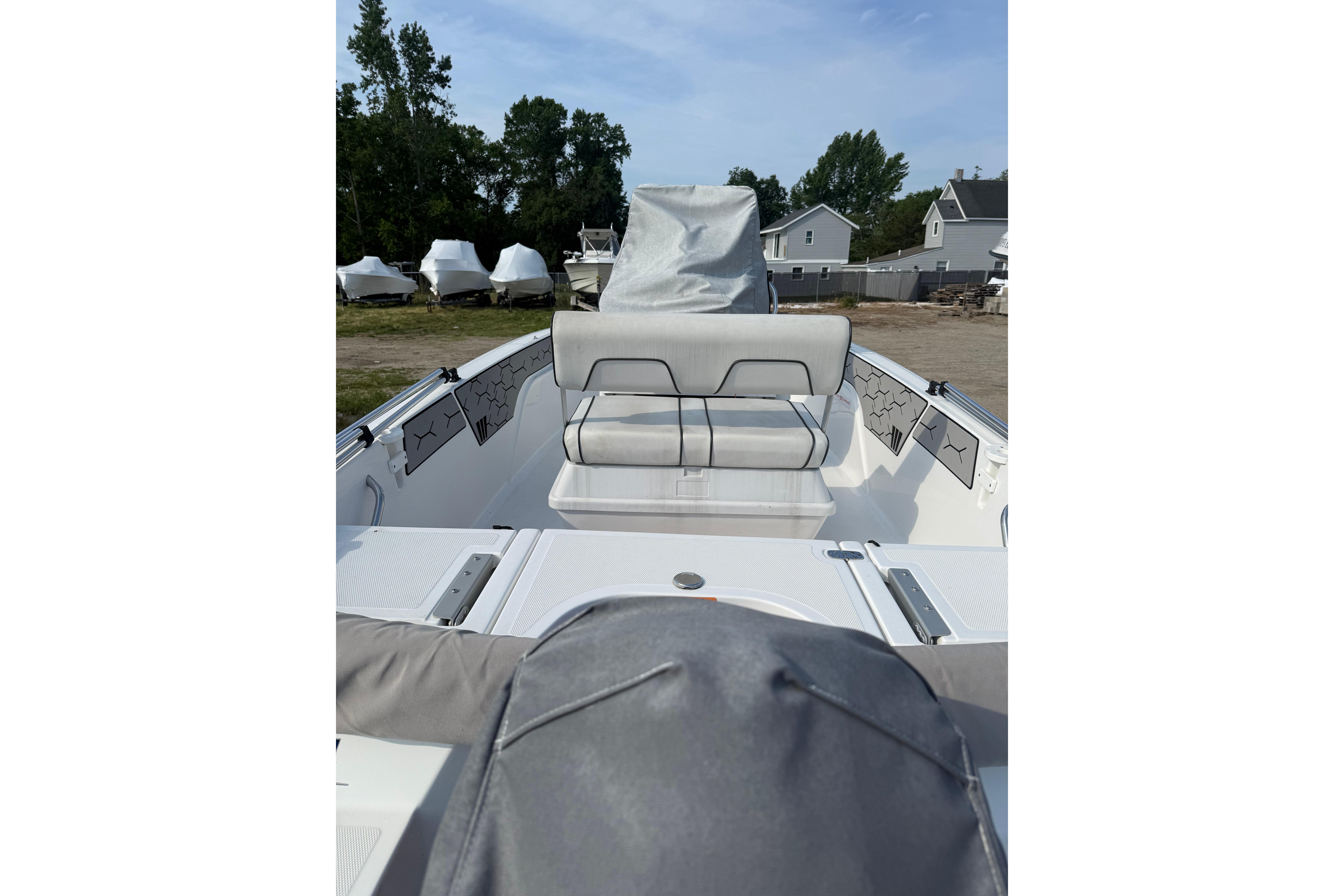 2020 Wellcraft 162 Fisherman boat interior with seating and storage, parked outdoors.