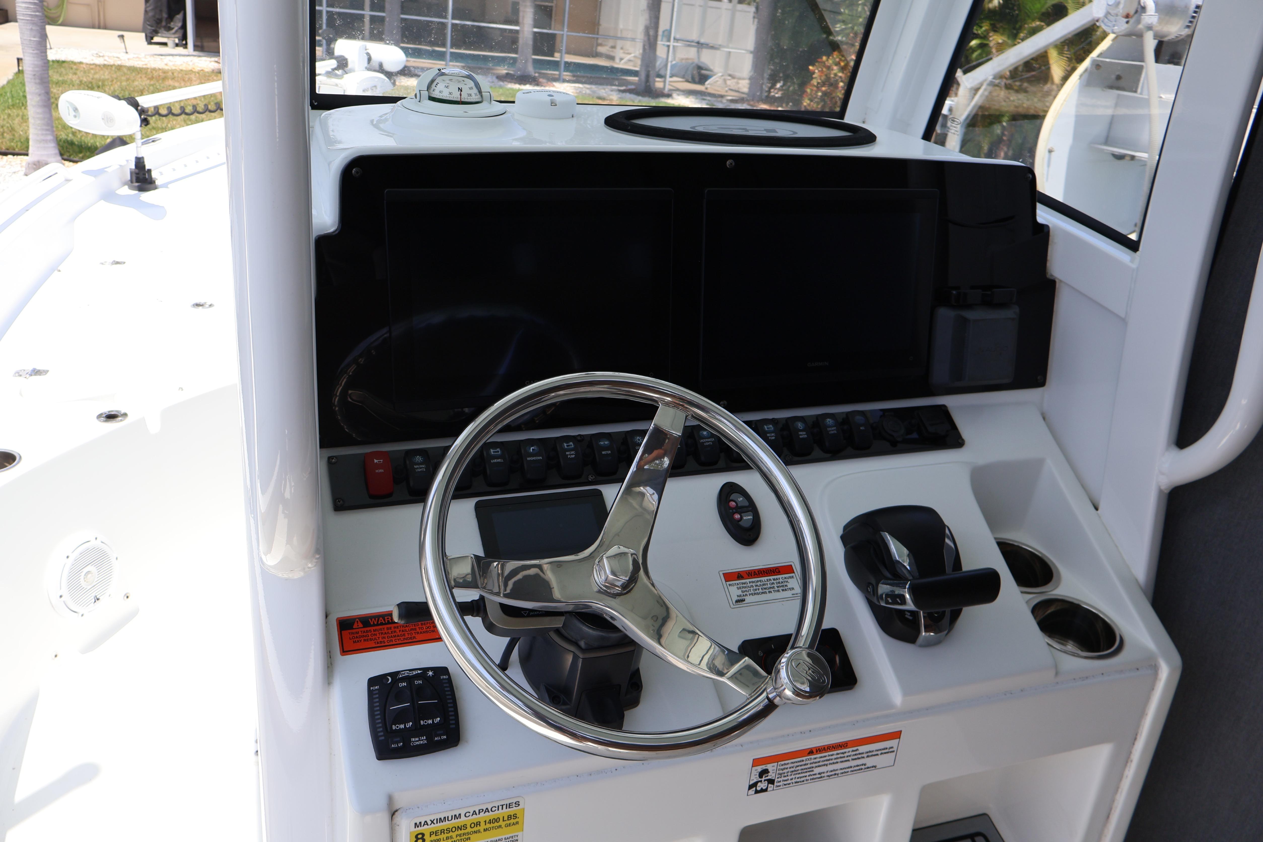 2022 Sea Hunt BX 25 FS boat dashboard with steering wheel and controls.