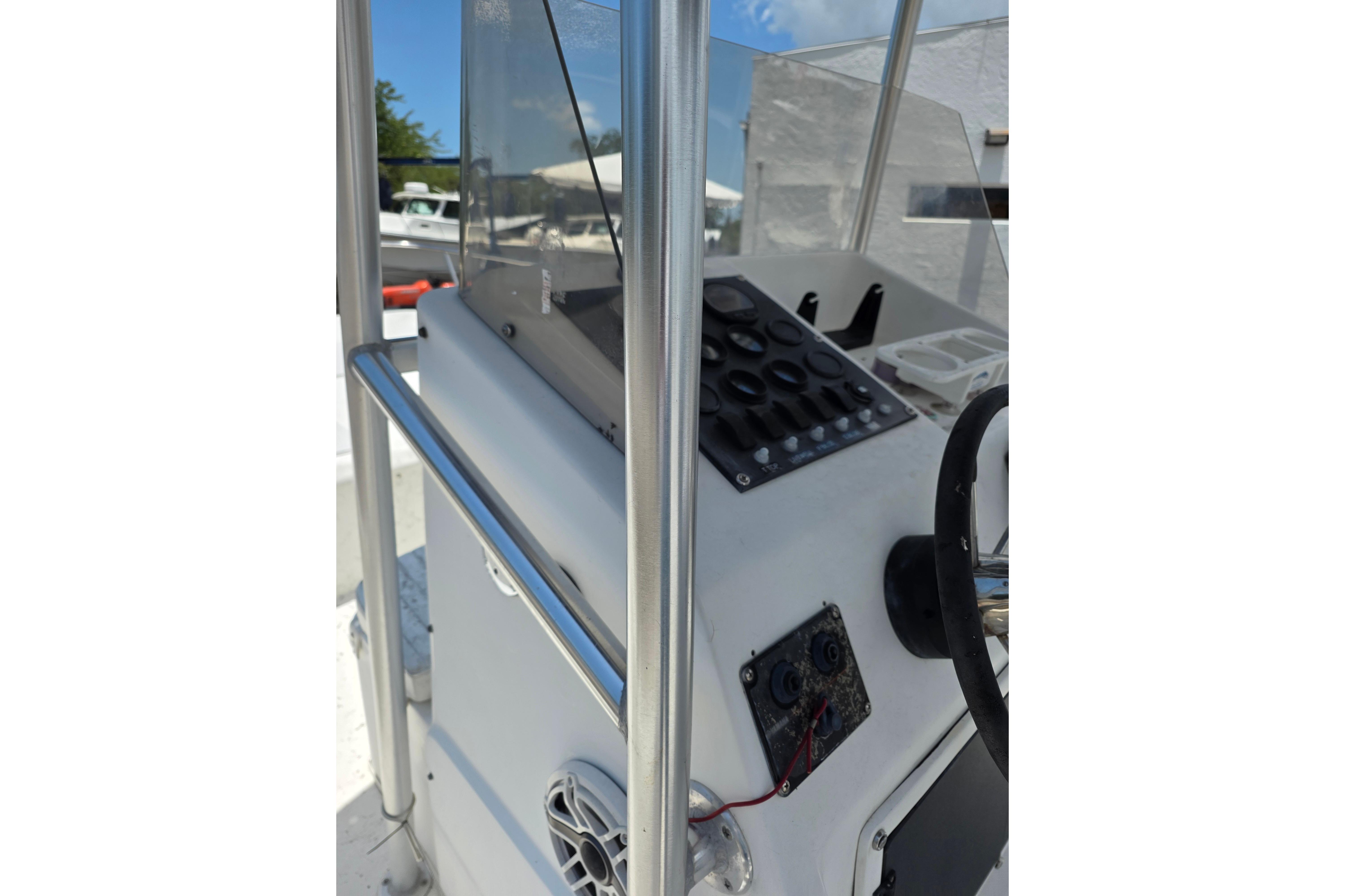 Console of a 1999 Twin Vee Awesome 22 boat with steering wheel and controls.