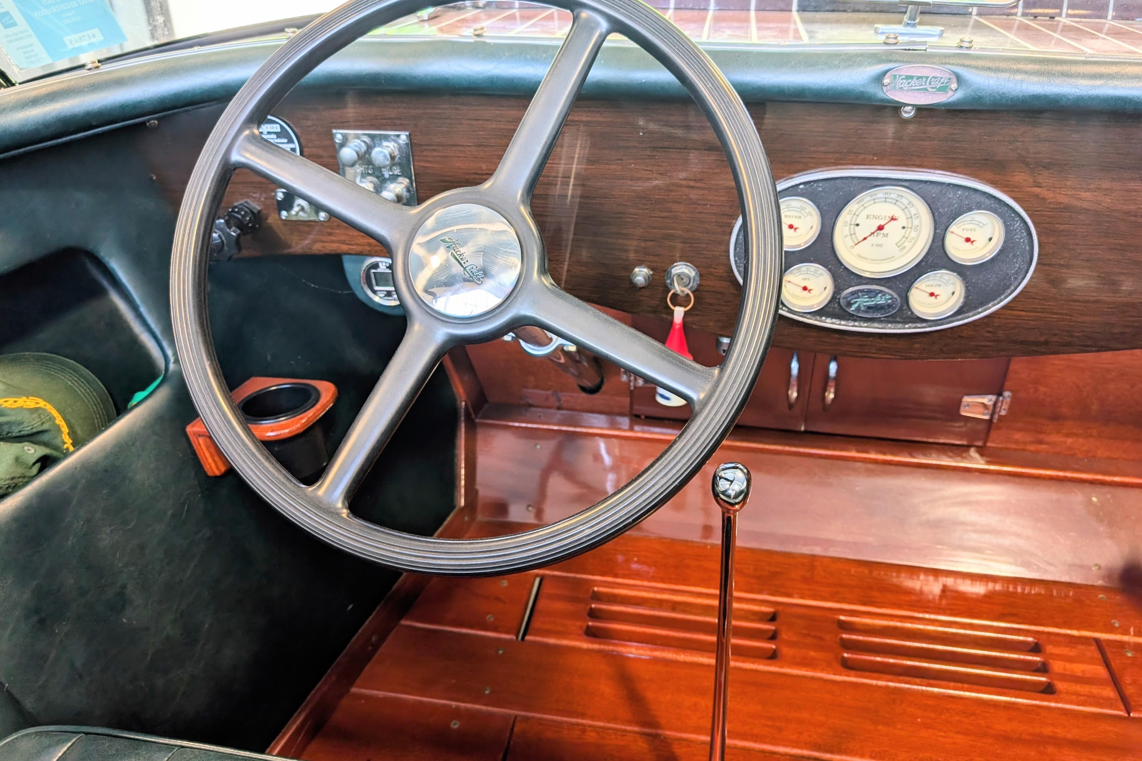 Interior of a 2001 Hacker-Craft 24 Dual Console with classic wooden dashboard and steering wheel.
