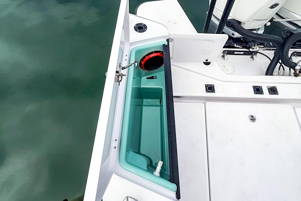 2023 Axopar 37 XC Cross Cabin boat deck with storage compartment and engine view.