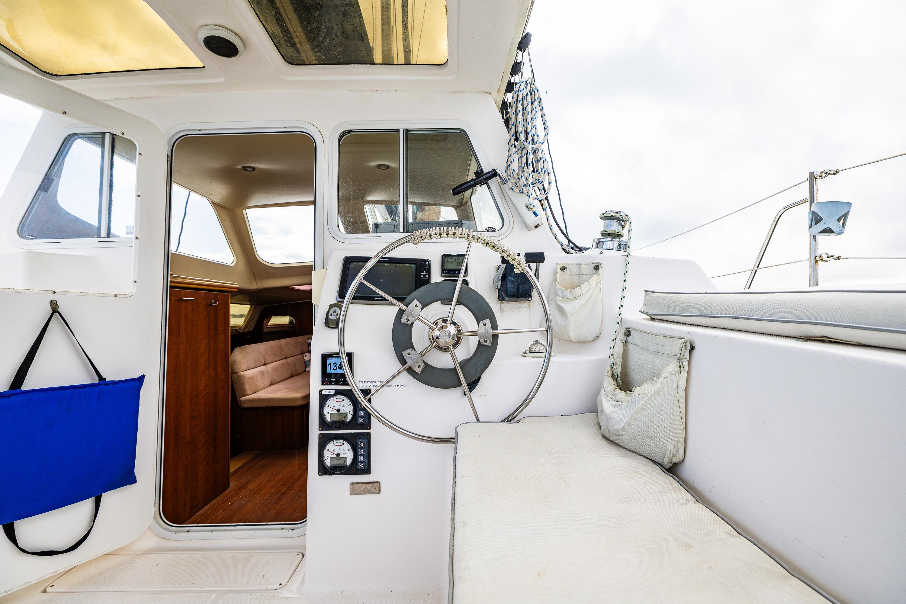 Interior view of 2014 Gemini Legacy 35 sailboat cockpit with steering wheel and seating.